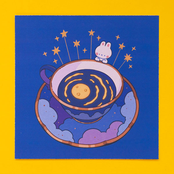 Art print titled "Moon Tea", showing a bunny peering into a teacup filled with a dark liquid. A glowing moon is submerged at the bottom of the liquid. The teacup sits on a saucer decorated with a cloud motif.