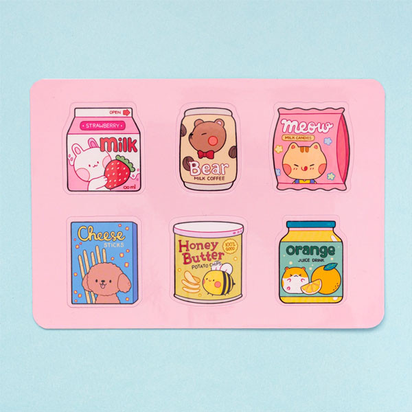 Sticker sheet featuring six snack-themed designs. The top row shows a strawberry milk carton, a coffee can, and a bag of candies. The bottom row shows a box of cheese sticks, a can of honey butter chips, and a bottle of orange juice.