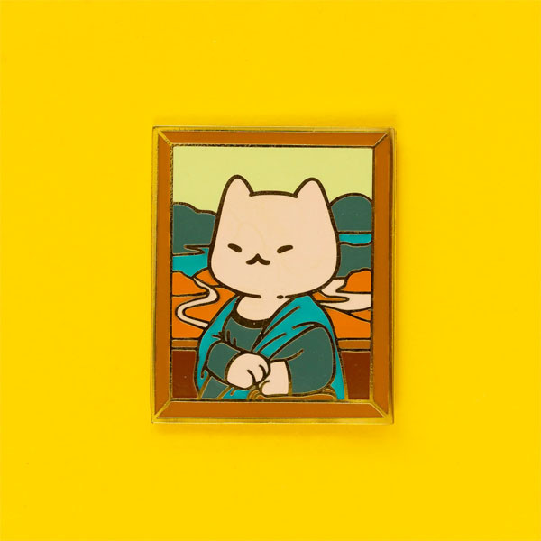 Enamel pin parodying Da Vinci's Mona Lisa, featuring a cream-colored cat in a green dress instead.