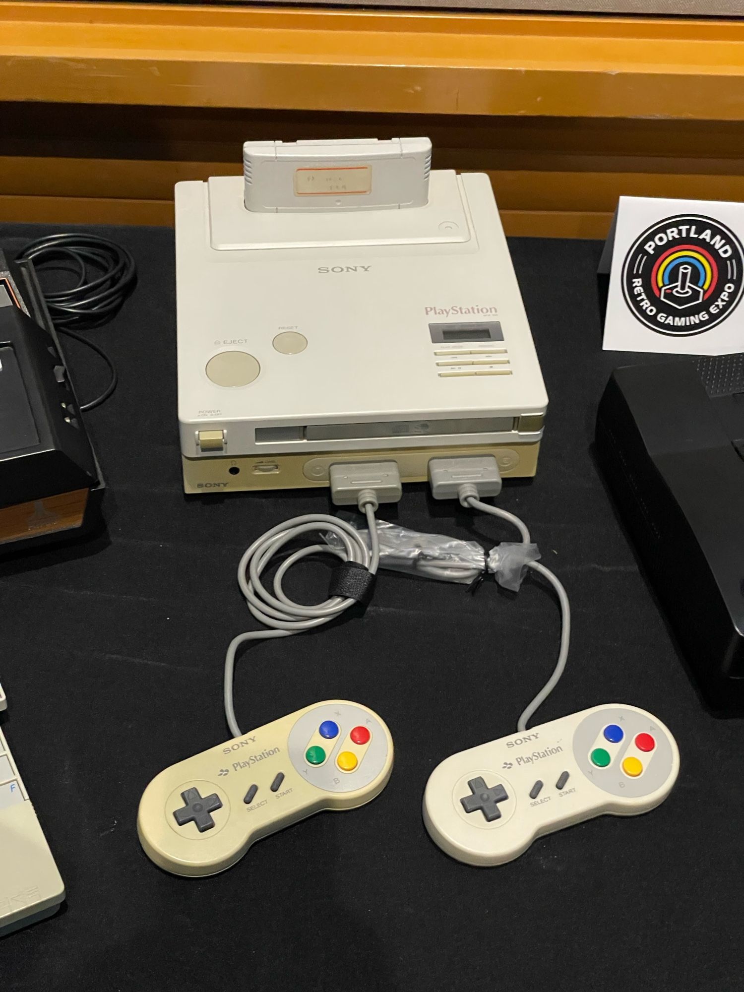 Nintendo PlayStation with cart and CD-ROM ports, two Famicom-like controllers with Sony branding