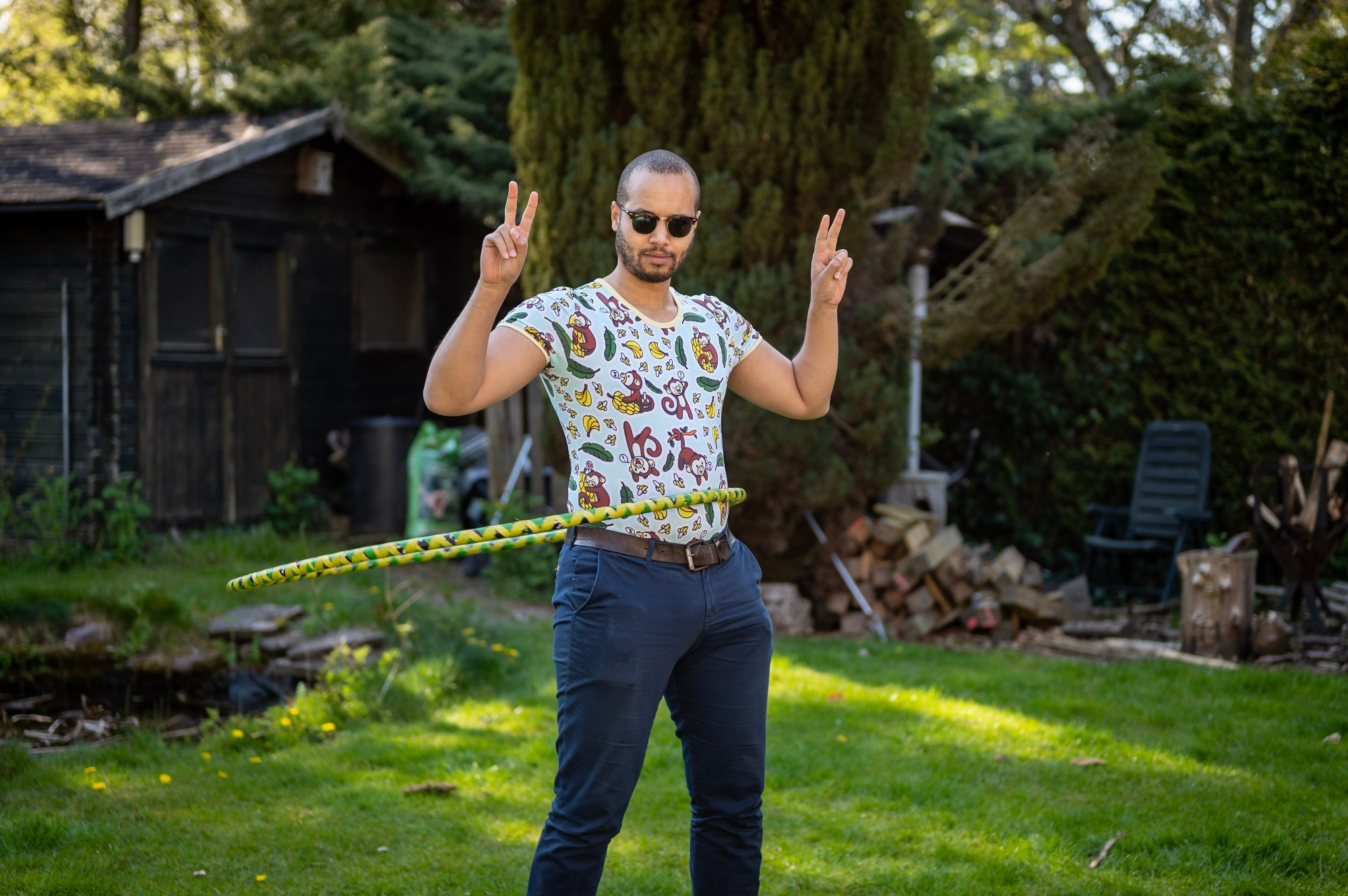 Guy with hoolahoop and onesie and diaper under jeans