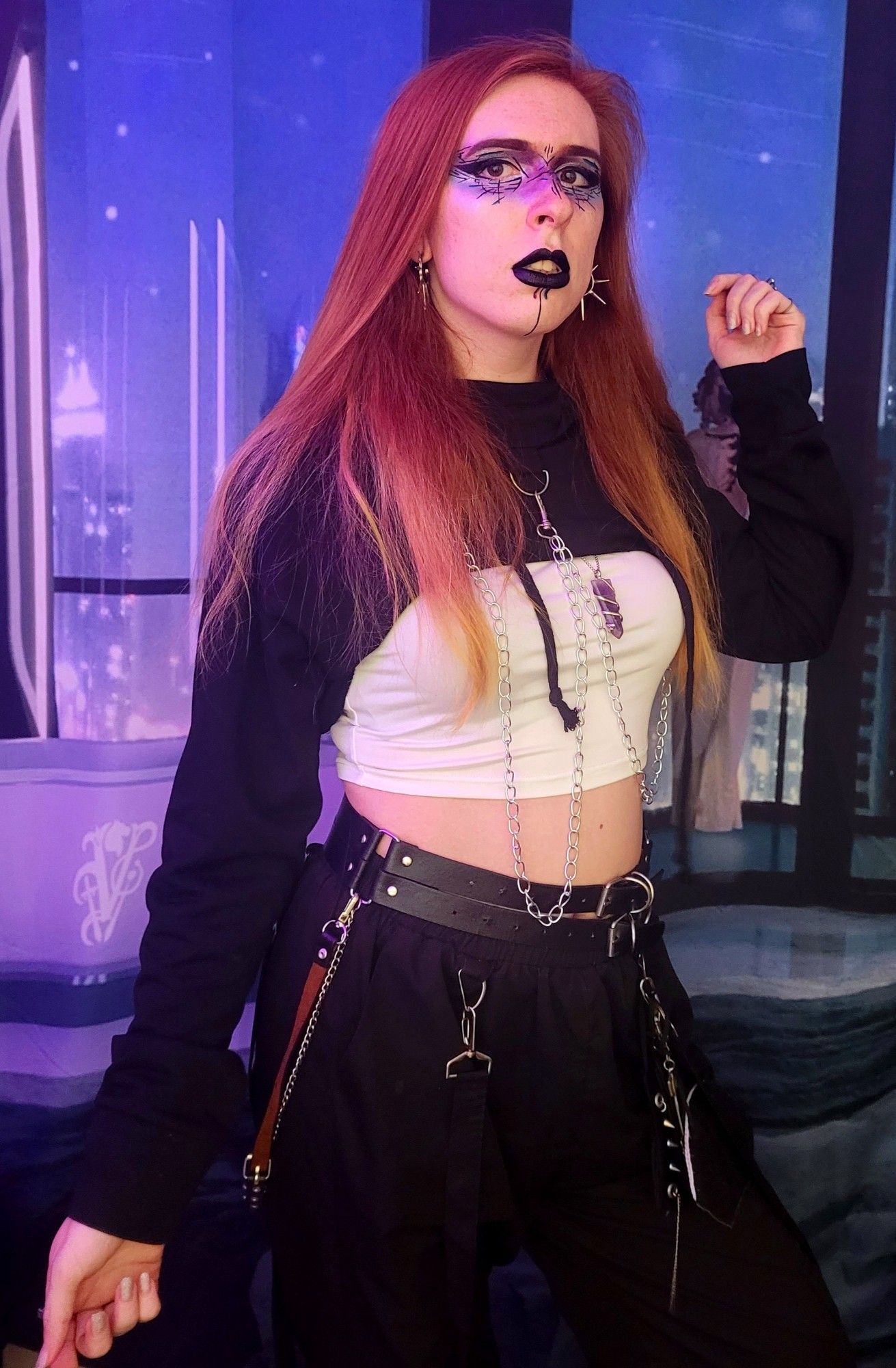 me with long red hair and cool makeup.   ive got cargopants on with a belt,  a white tube top,   and a hoodie style super cropped thing above it.   it all looks very cyberpunk.