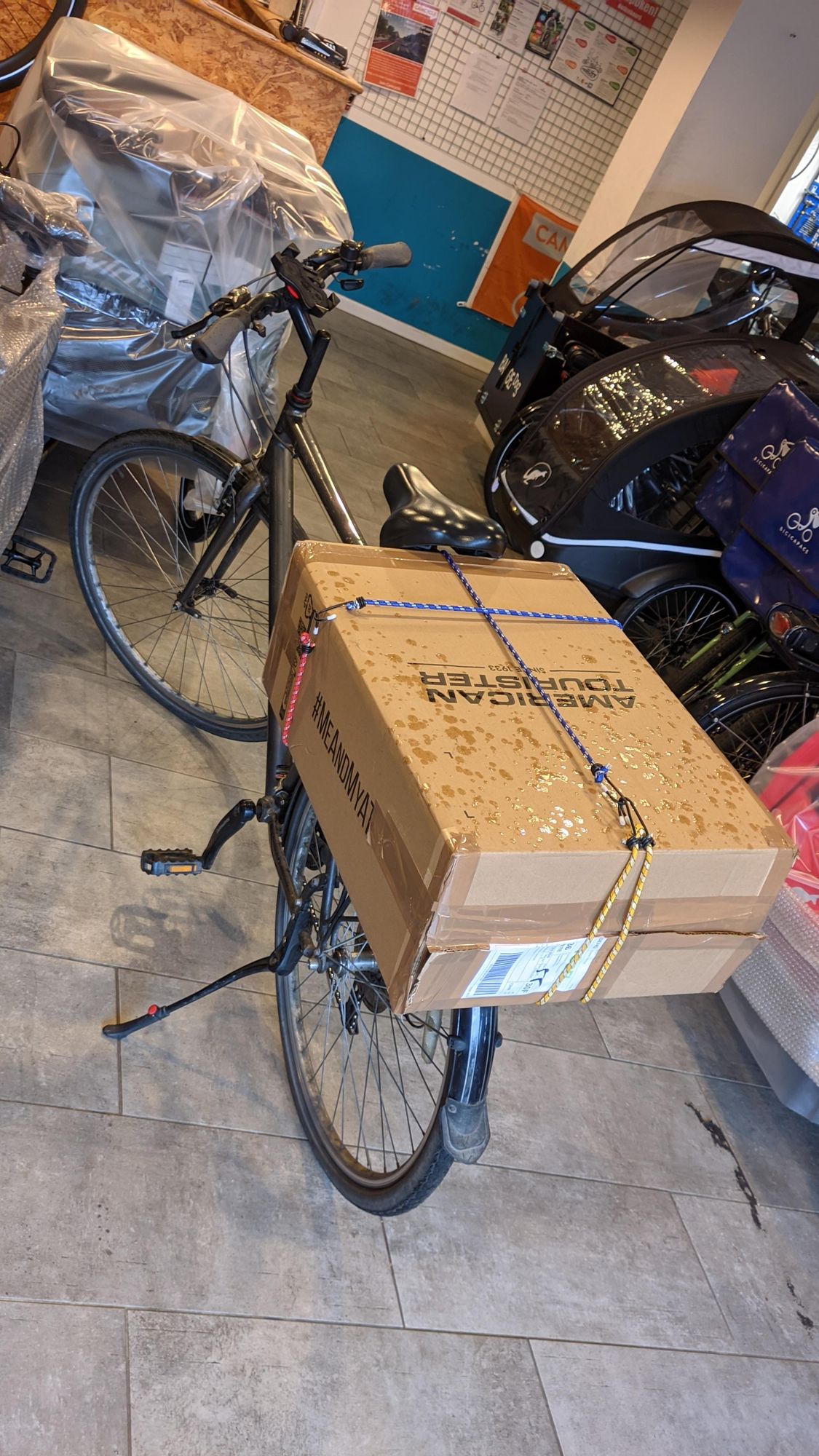 A humble road bike with a FollowMe box mounted on the back so I could take it to a bike shop to have it installed.