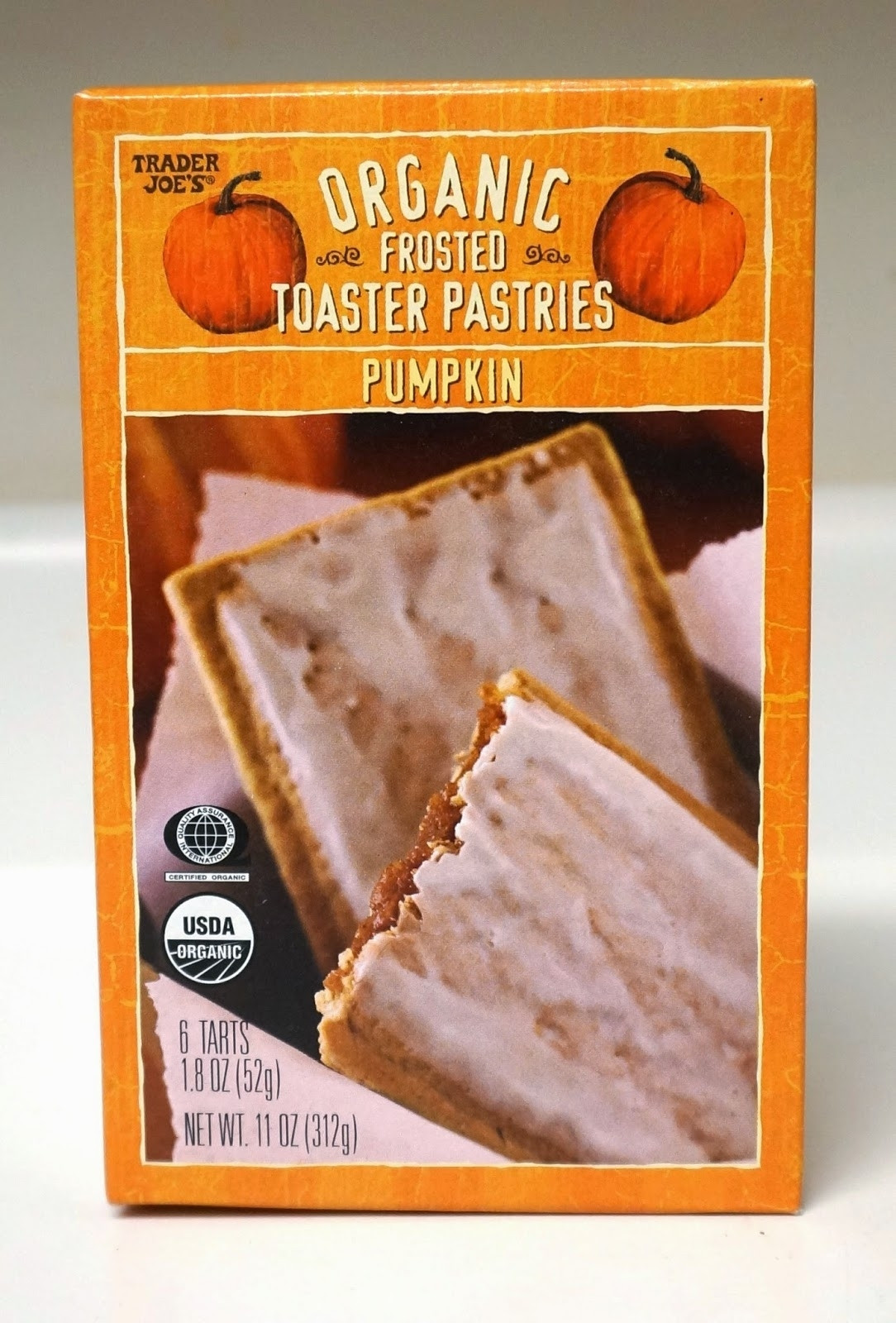 An orange box with an image of a frosted pop tart that says "Organic Frosted Toaster Pastries - Pumpkin"