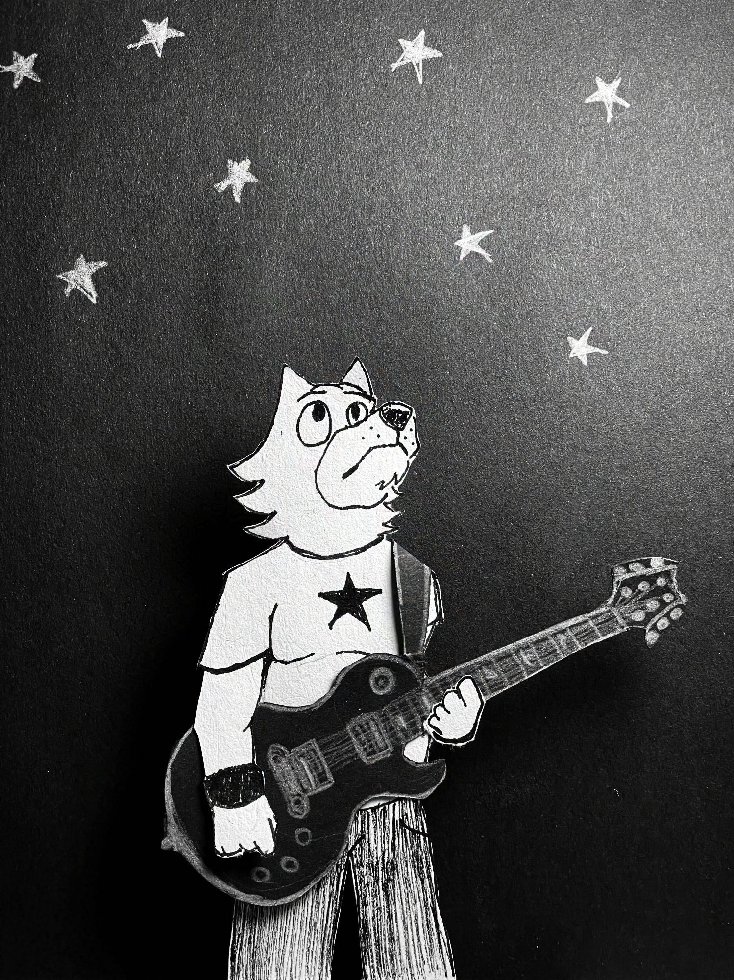 A black and white drawing of a cartoon anthropomorphic wolf man wearing dark pants and a white t-shirt with a black star on it. He's holding a black Les Paul style electric guitar with one hand on the neck and another on one of the volume knobs. He stands in front of a black background, and he's looking at the stars above him.