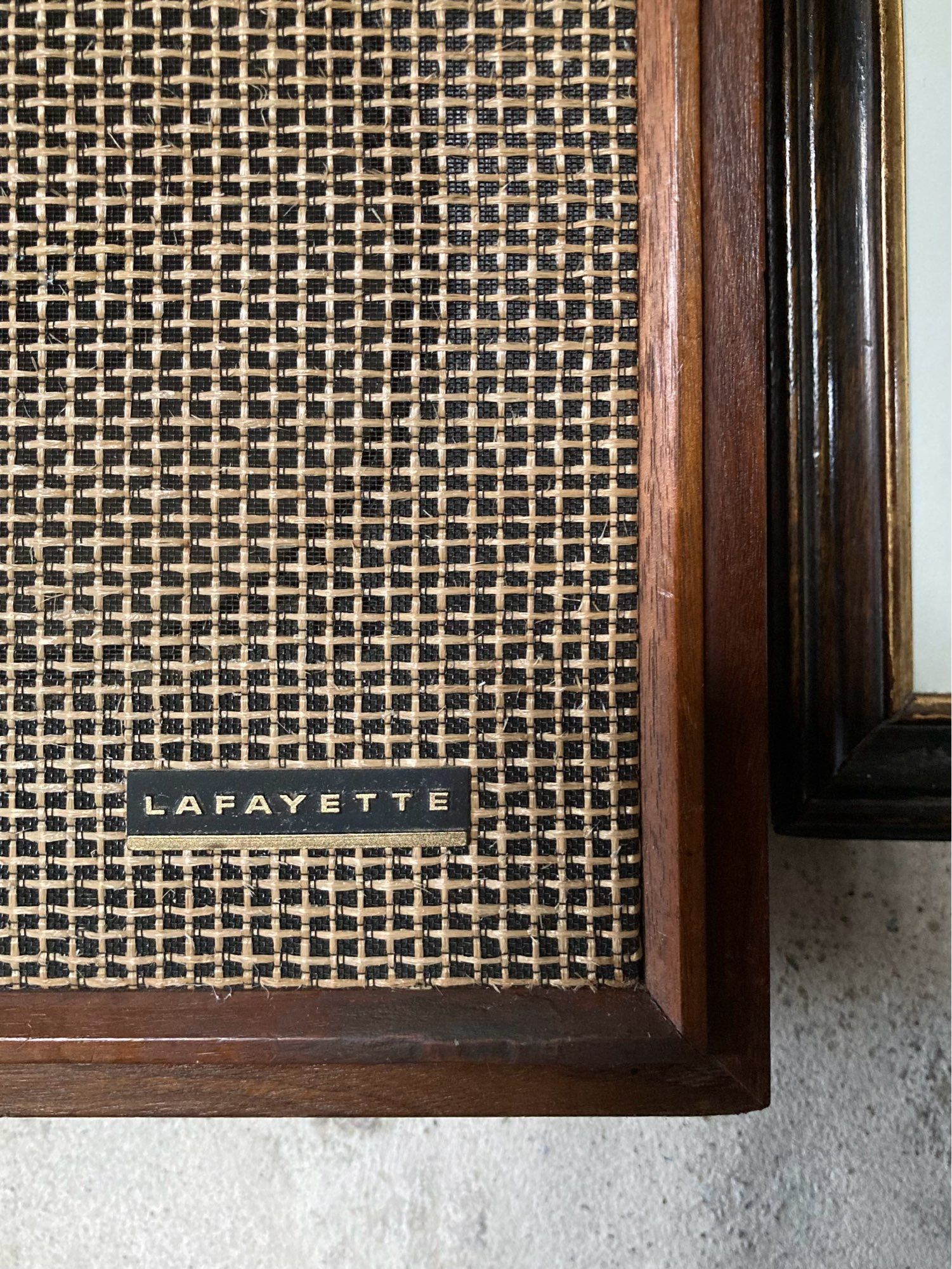 Close-up of the gold grille on the front of a vintage Lafayette speaker, with dark wood surround. Part of the excellent immersive sound piece ‘Song (after Nature)’ by Paul Rooney at Lindisfarne Castle, August 2023.