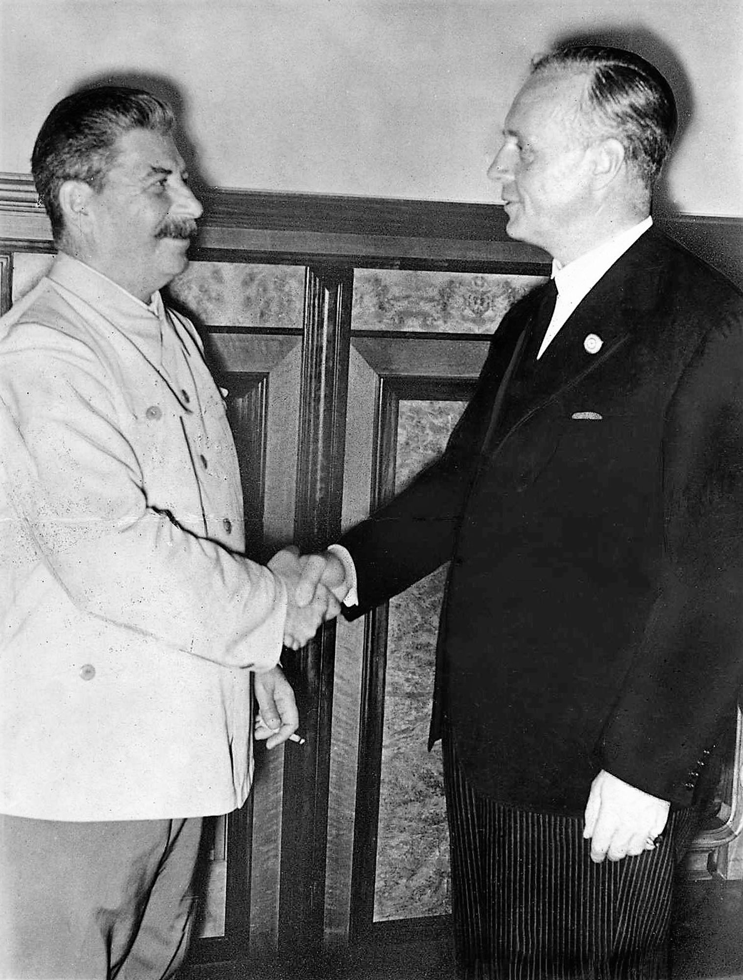 Socialist hero Josef Stalin warmly greets fascist diplomat Joachim von Ribbentrop after they work out an agreement to carve up Poland. (August 1939)