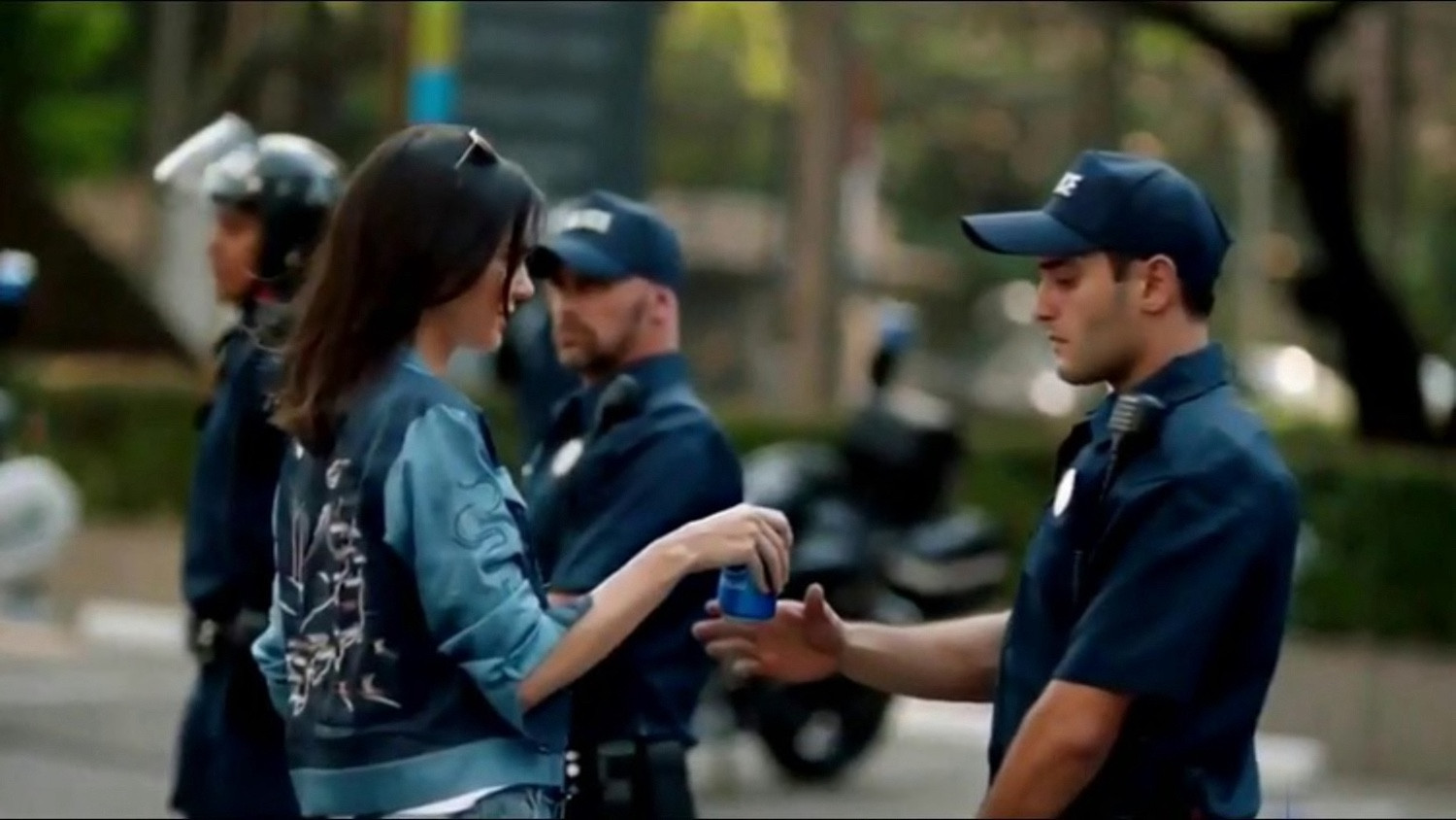 Kendall Jenner handing a cop at a protest a Pepsi