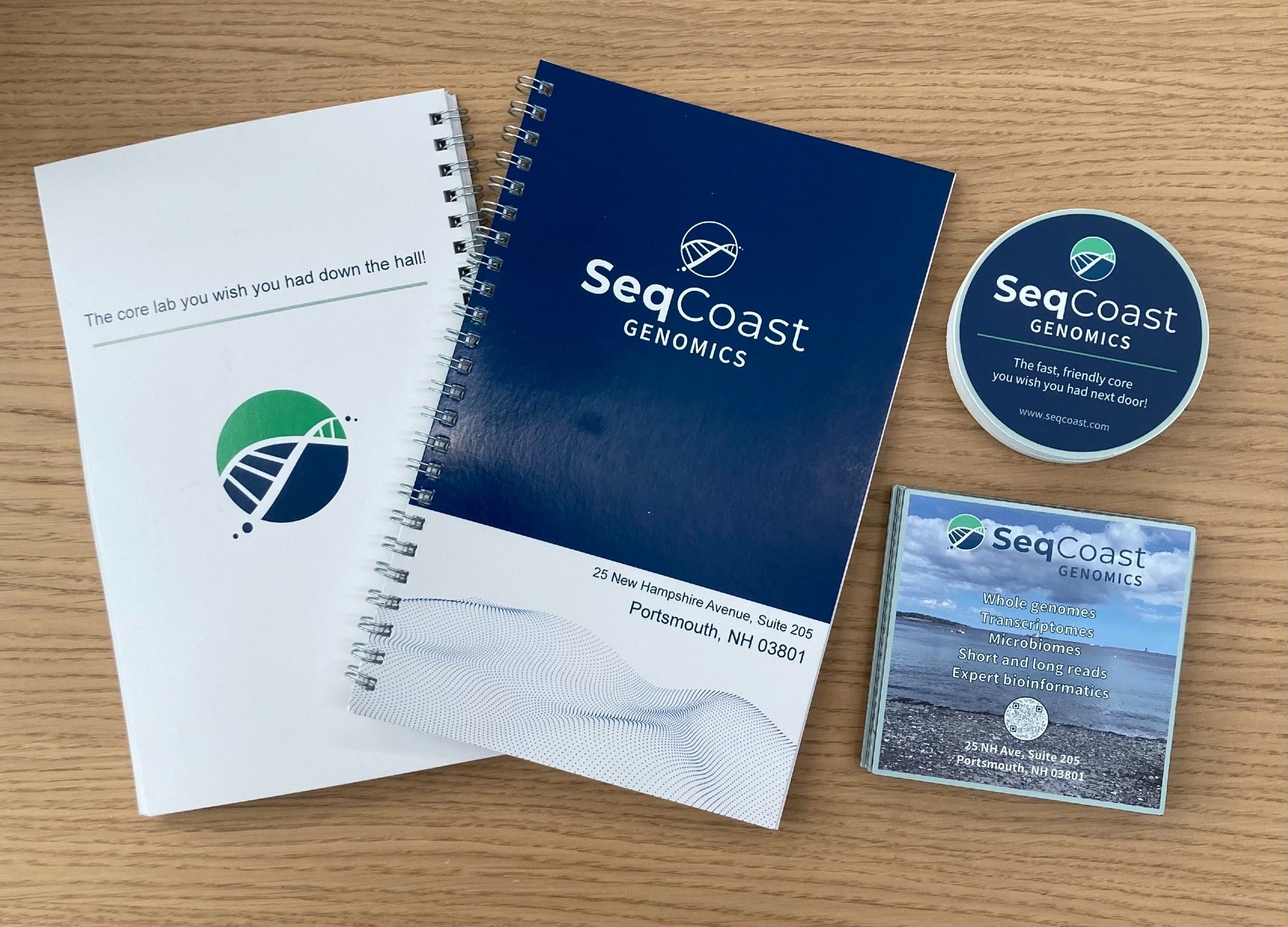 Image of SeqCoast-branded notebooks, stickers, and magnets