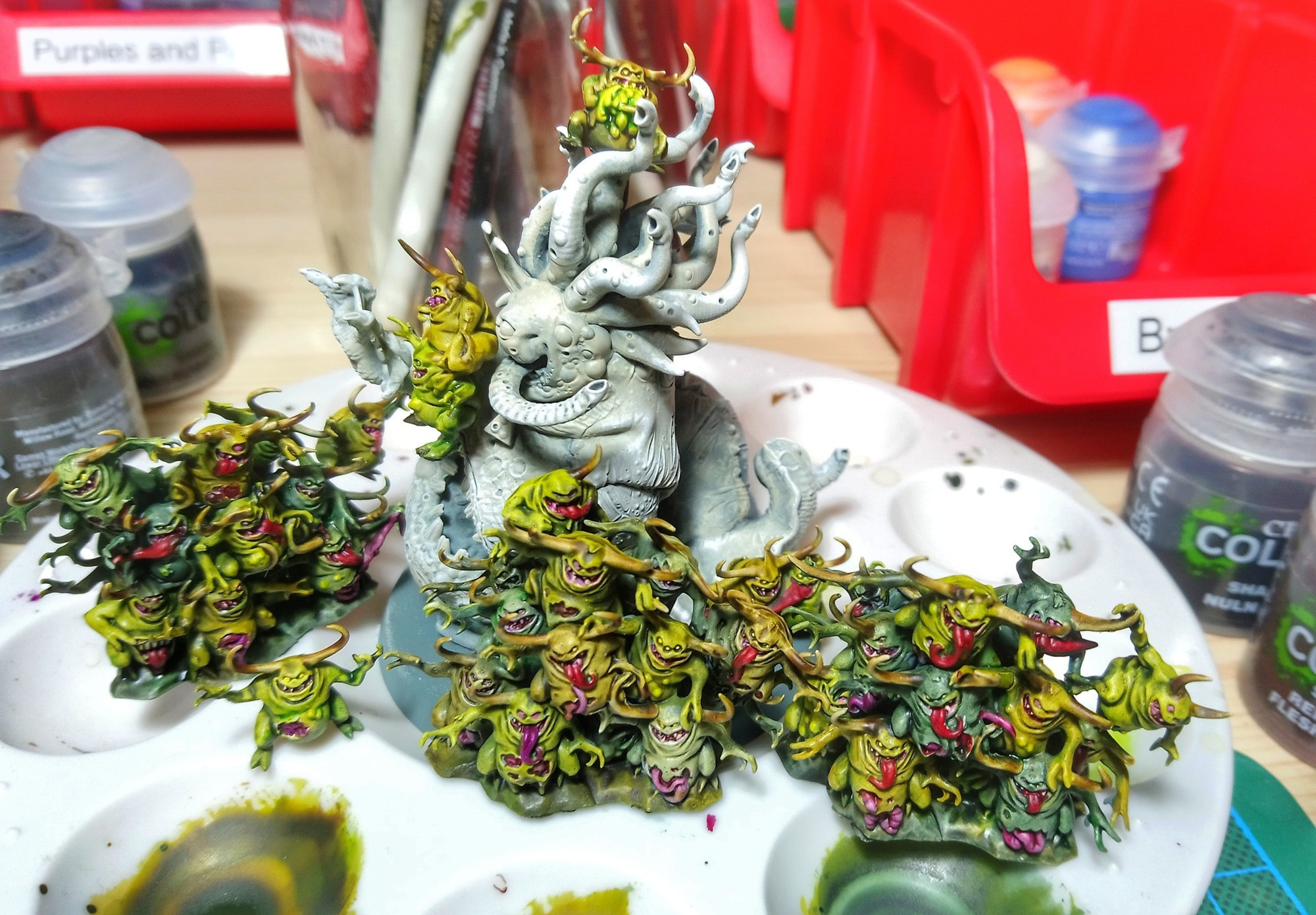 Painted Nurglings infesting an unpainted Beast of Nurgle.