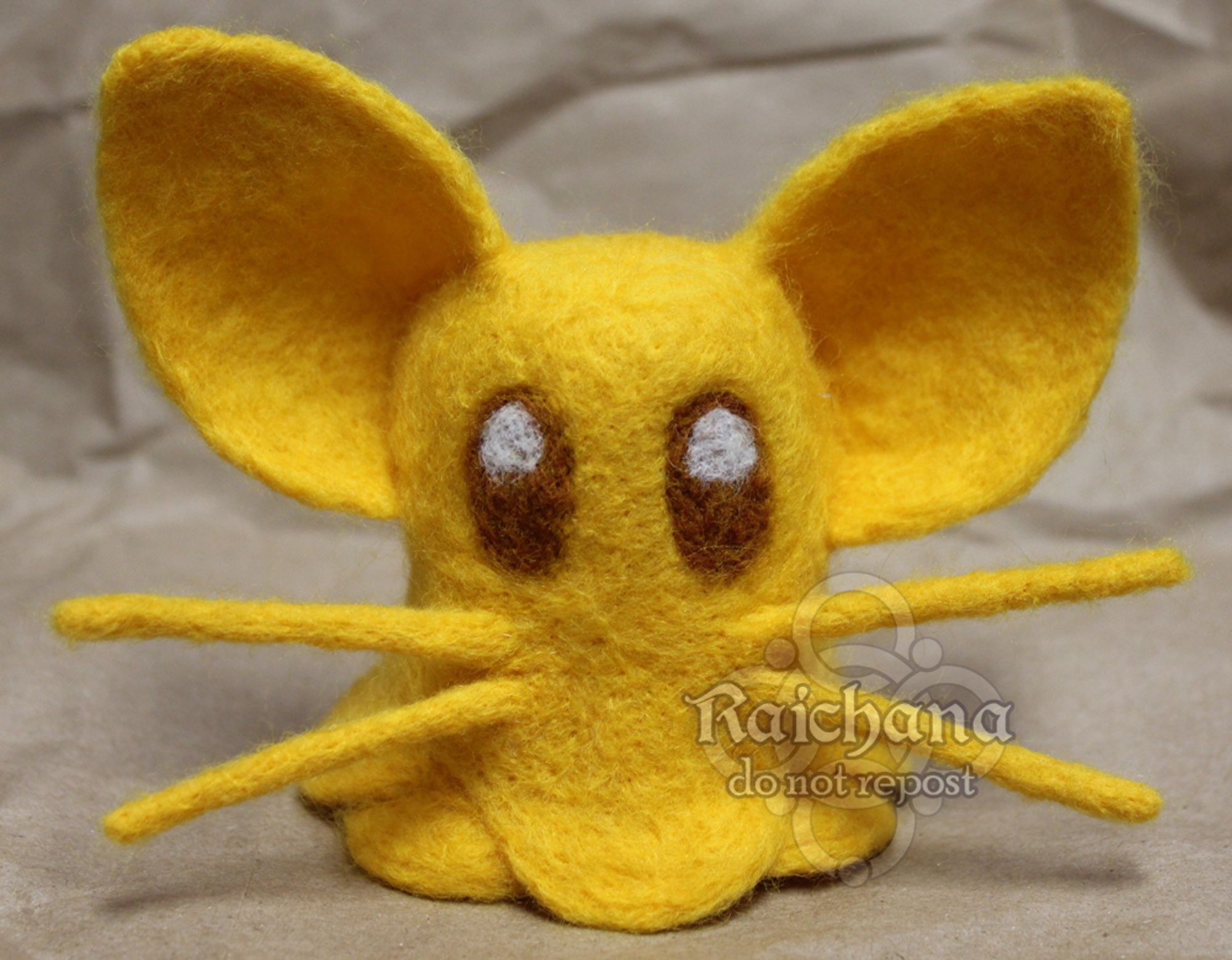 A pol's voice I was commissioned to make. Traditional commissions need to be confirmed either through DMs or etsy but I am happy to do them for felts or paintings. 
this little pols voice is made of yellow merino wool and brown wool for the eyes. the ears are very big and it is based on the zelda 1 sprite. 