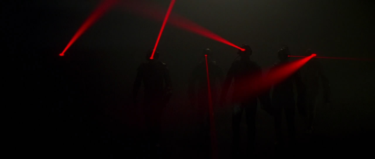 Still from FIRST CONTACT of the Borg, shrouded in darkness, appear only with their head-mounted laser pointers shining any light 