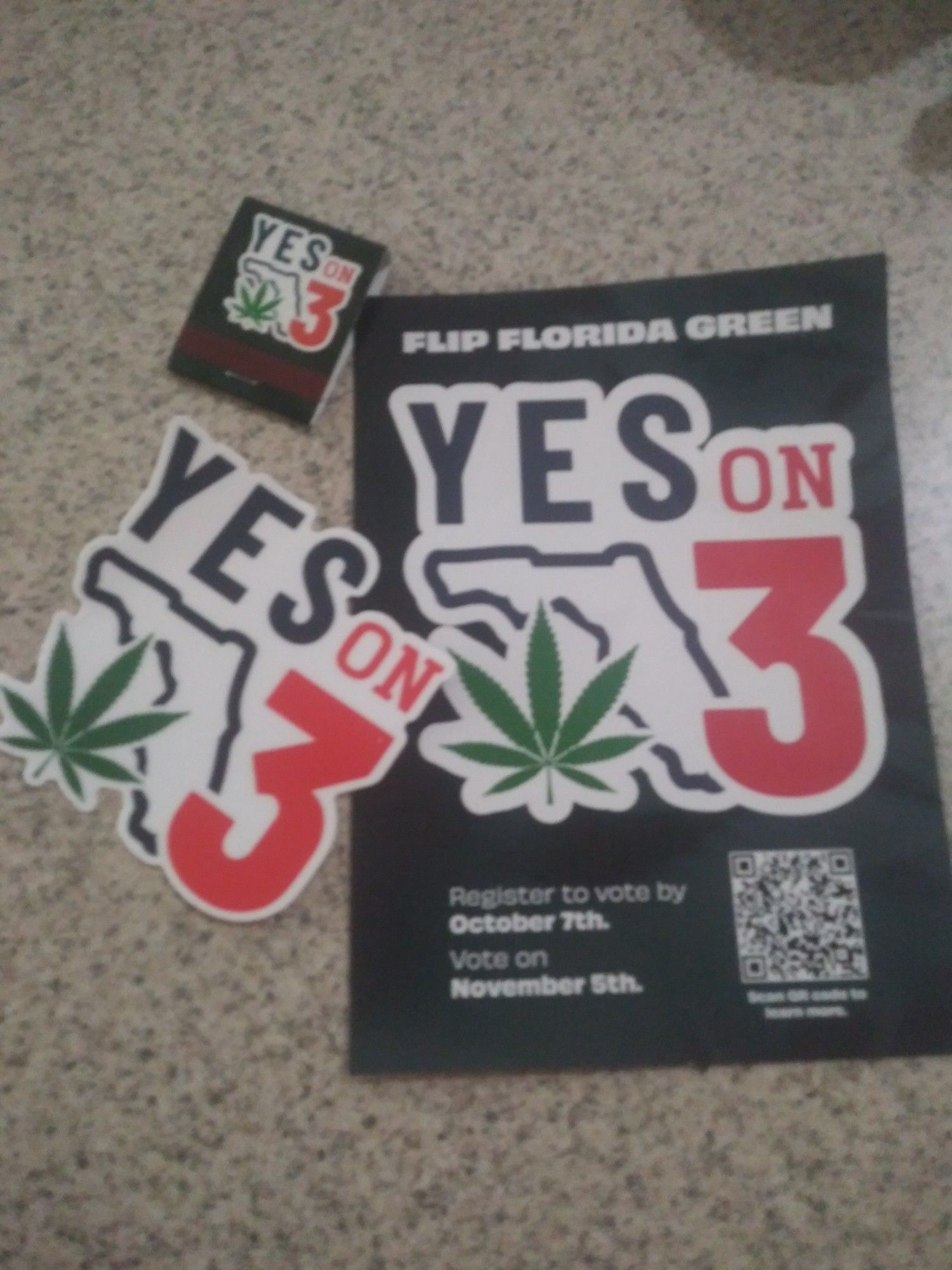 A "Yes on 3" sticker, matchbook, card. They want ppl to vote for recreational cannabis as opposed to it remaining medically prescribed.