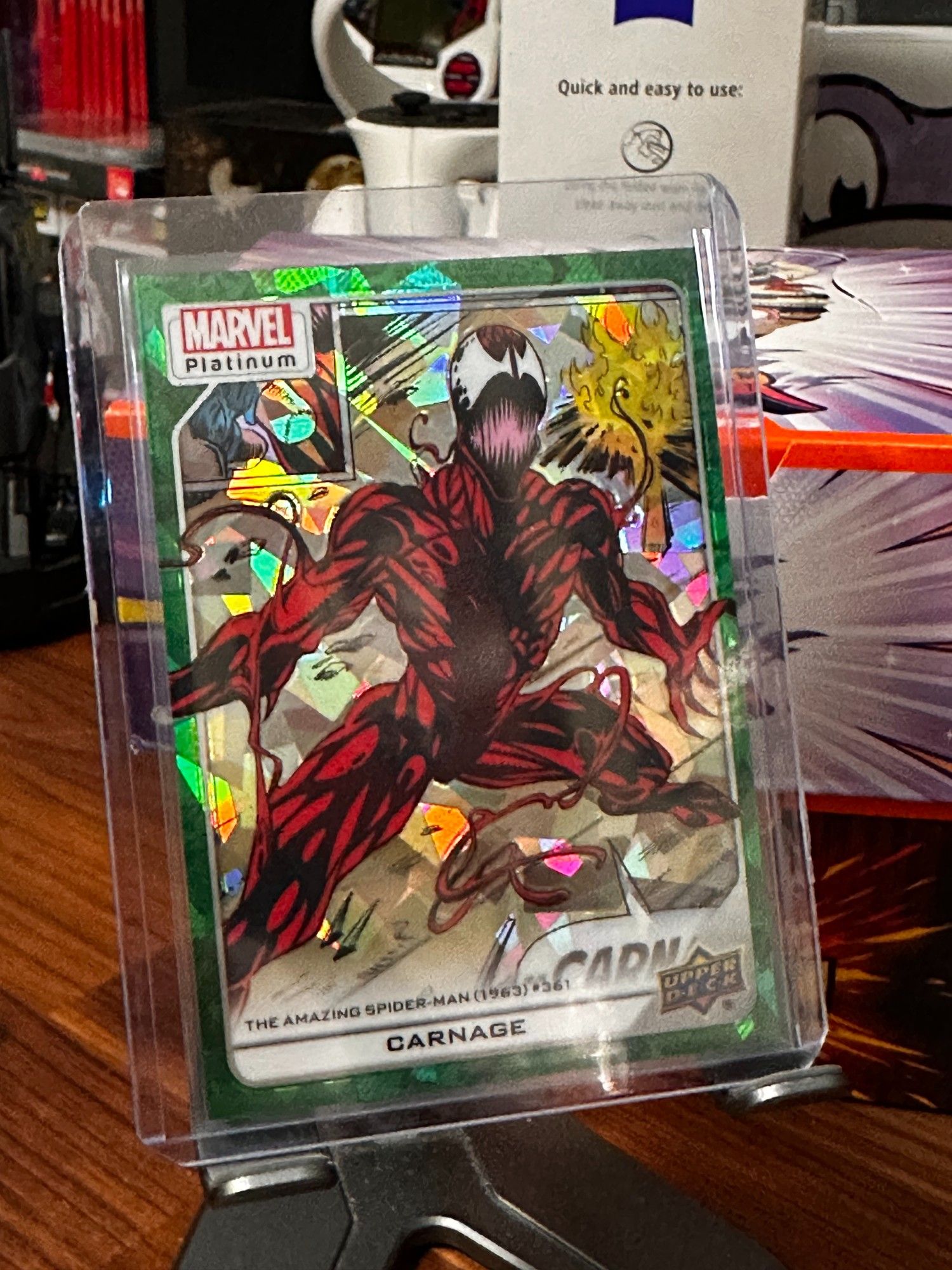 Upper Deck Marvel Platinum - 
Carnage - in a pose from The Amazing Spider-Man #361 - where his arms are stretched out to the side and chest faced out. 
Green Crackle parallel (background is "cracked" green holofoil)