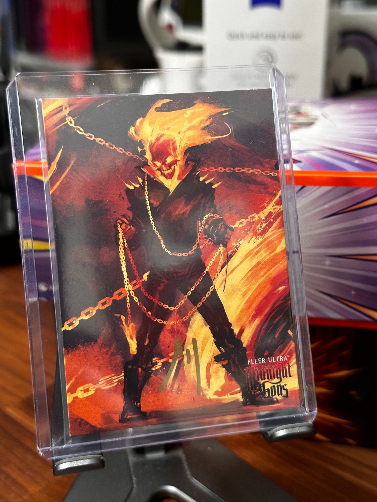 Fleer Ultra - Midnight Sons Ultra Shades (US-29) - 
Ghost Rider Art, displaying him standing in a post with his chains circling around him. 
Autographed by Artist - Andre Meister