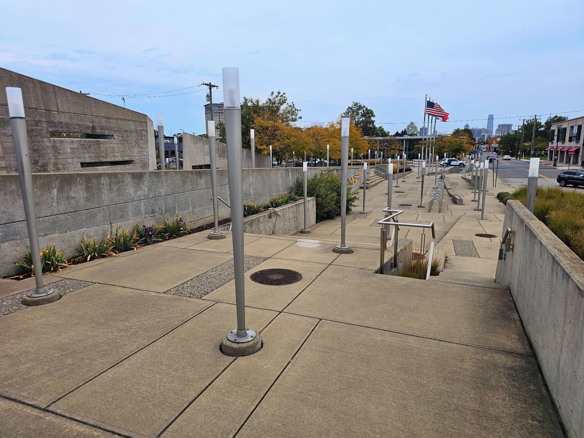 Looking at the tiered pedestrian plaza at the foot of the bridge. It's almost entirely concrete and there are no visible seating areas.