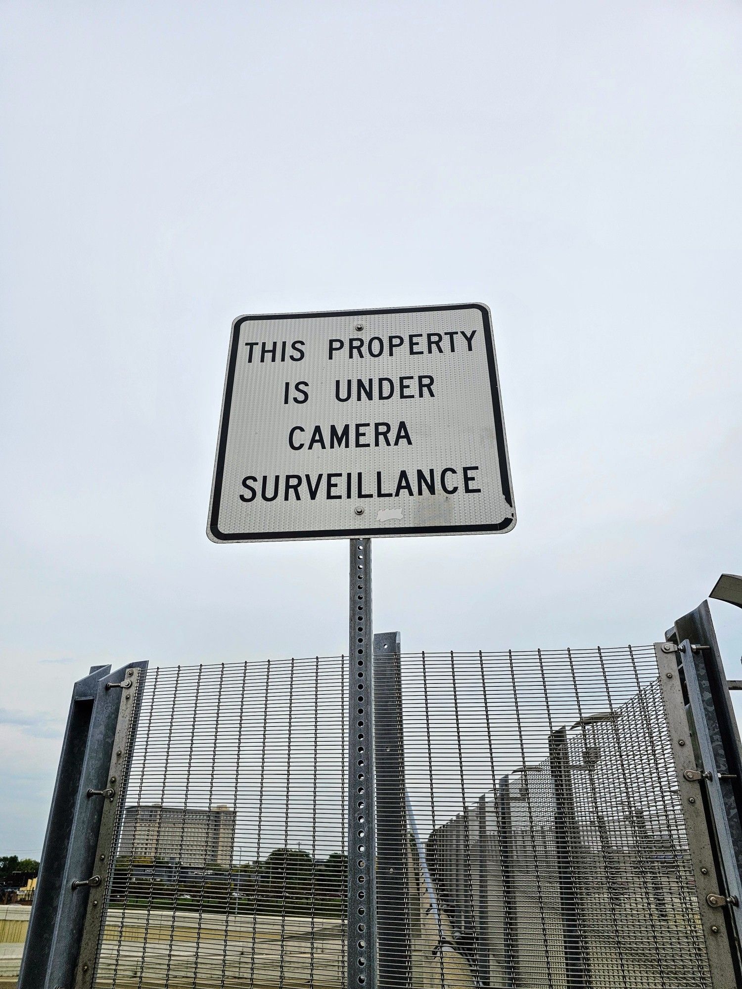 A sign: THIS PROPERTY IS UNDER CAMERA SURVEILLANCE