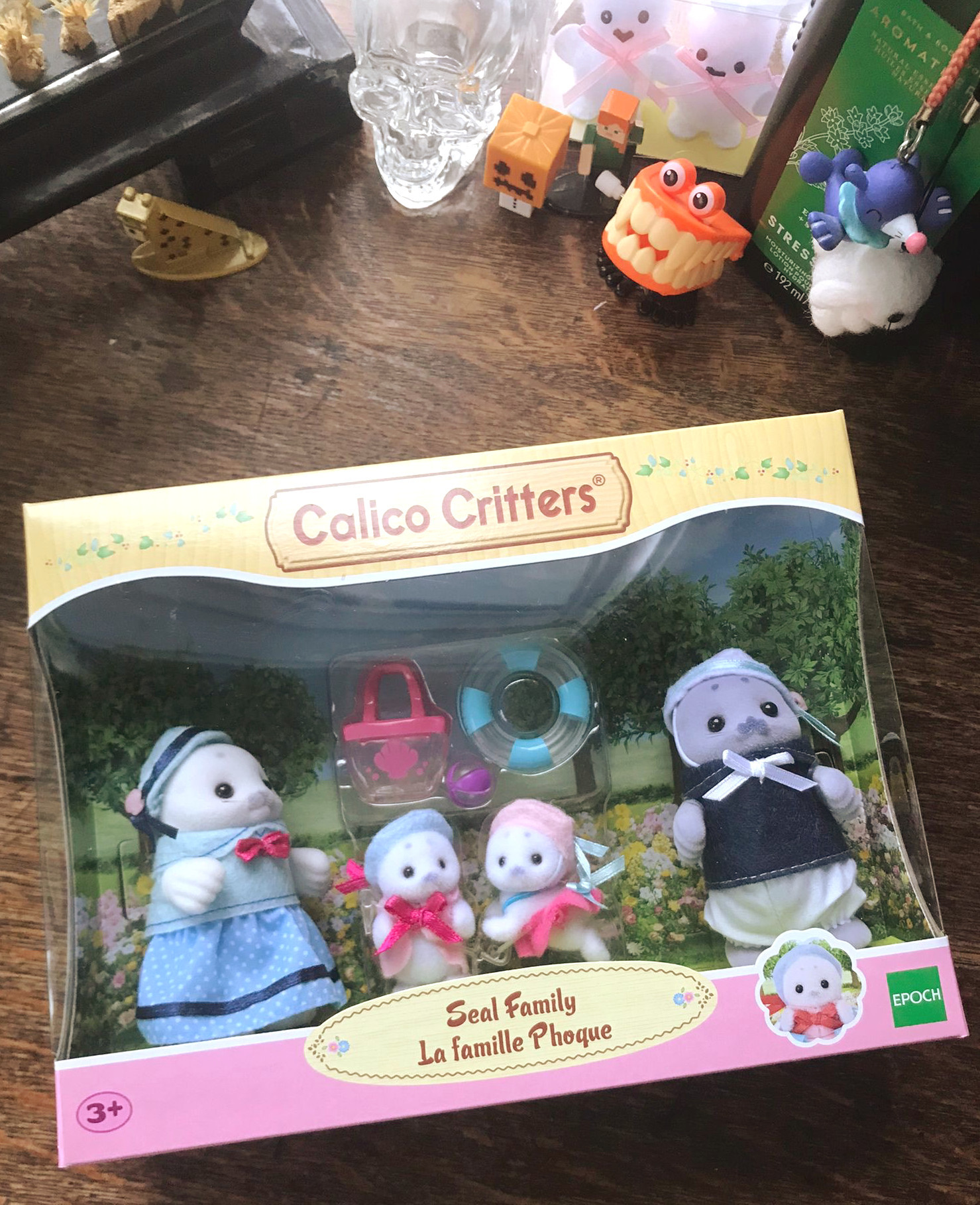 A photo of the Calico Critters seal family in a box on my desk.