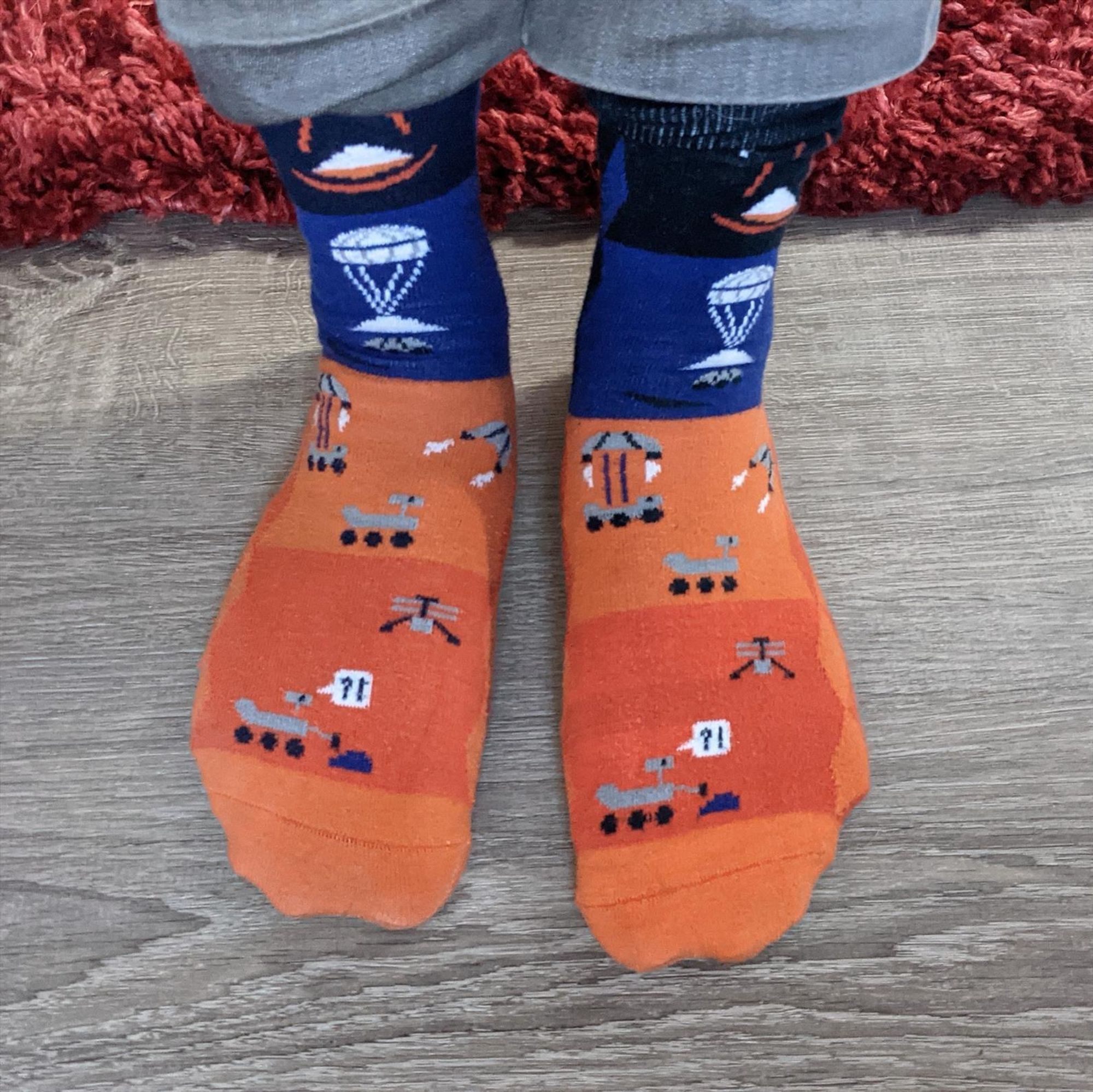 Daniel wearing Perseverance rover socks 