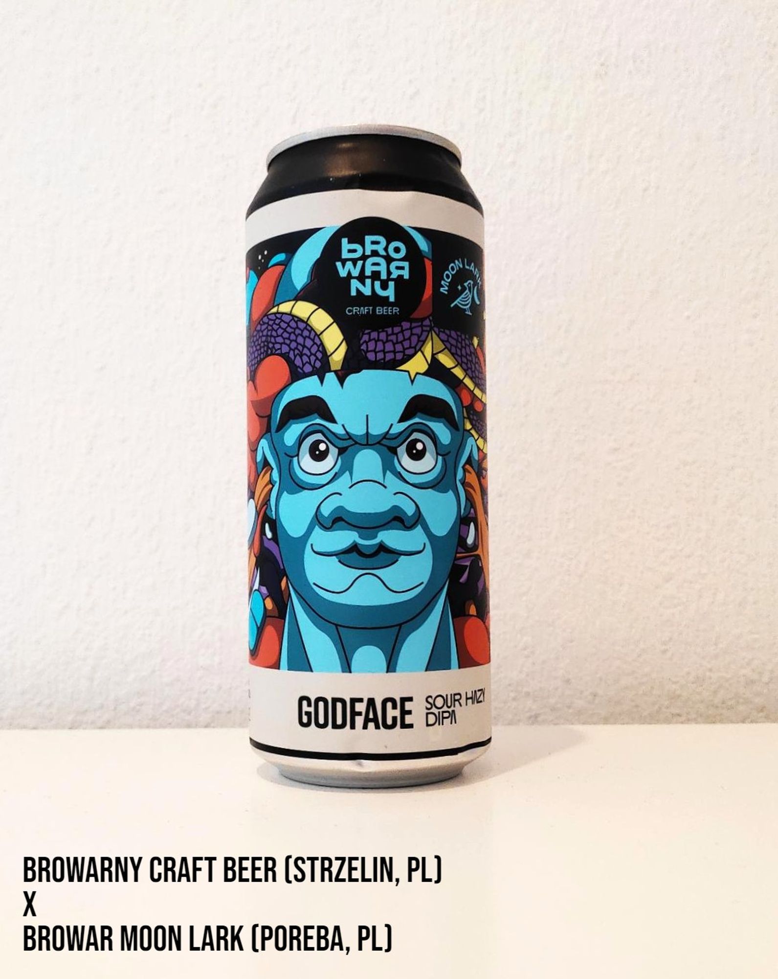 A 500 ml can of beer by Browarny and Moon Lark breweries from Poland. The colorful label has a large blue face on it.