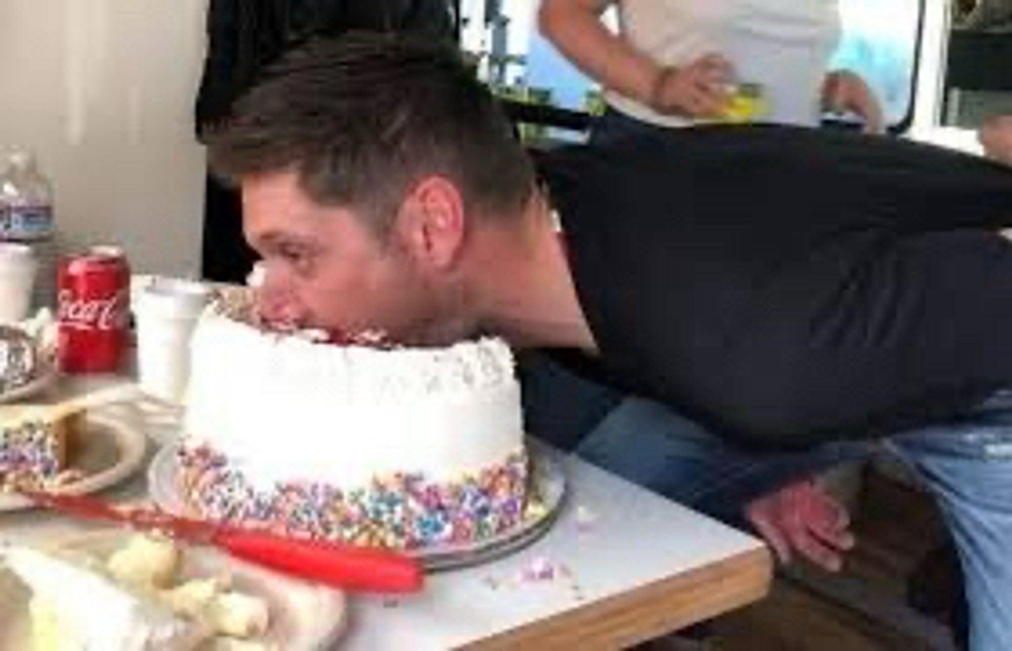 Jensen Ackles faceplanting a birthday cake. On purpose.