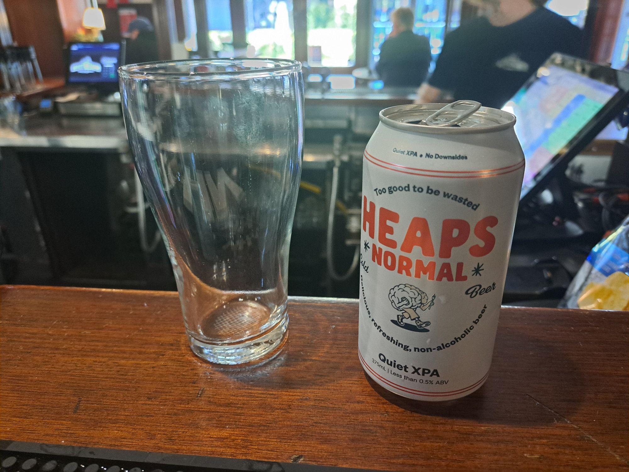 Photo of the bar at the Tudor Hotel with my can of Heaps Normal and an empty glass.