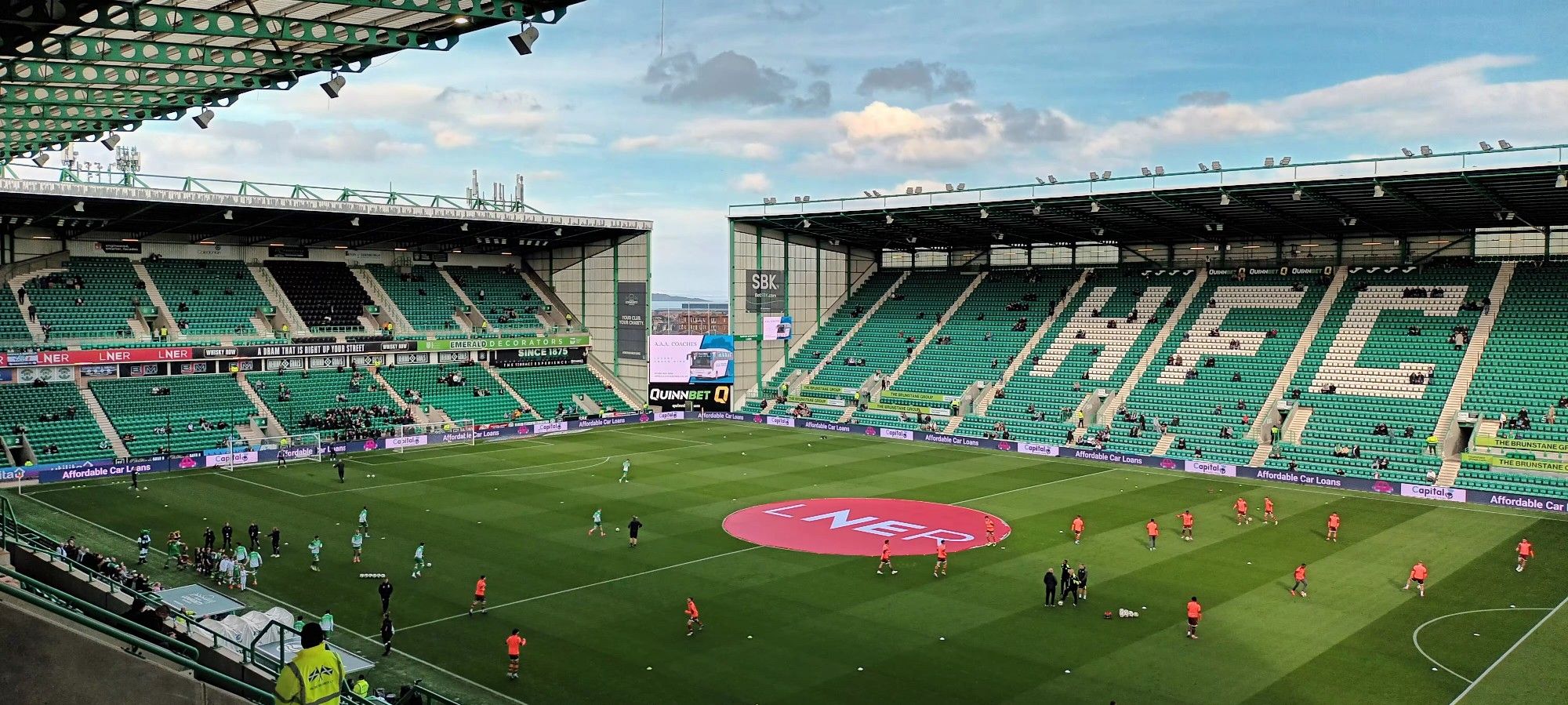 Photo shows two football stands of Easter Road Stadium. It's pre match between Hibs and Motherwell. Motherwell players are warming up on the pitch. Photo by Brian McRoberts 2024