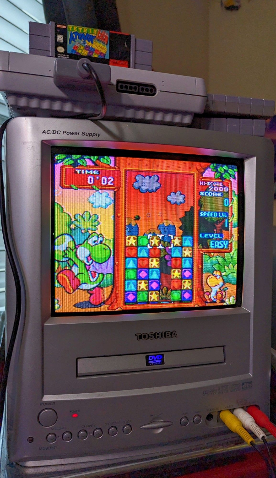 The puzzle game being played on the television.