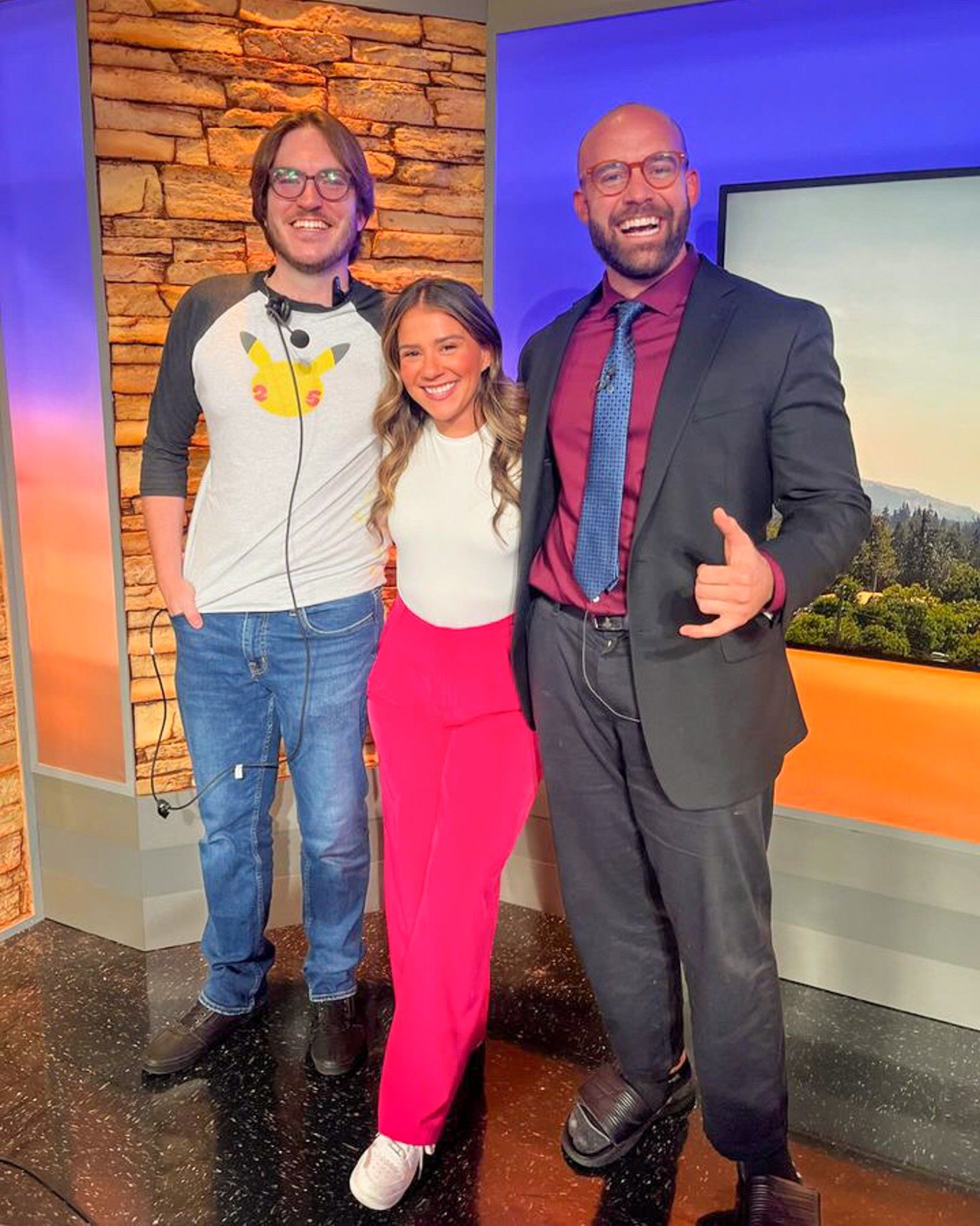 SOJC alums Zach Bruhl ’20, Brianna Chavez ’21, and Billy Spotz ’22 pose for a photo together in a newsroom.