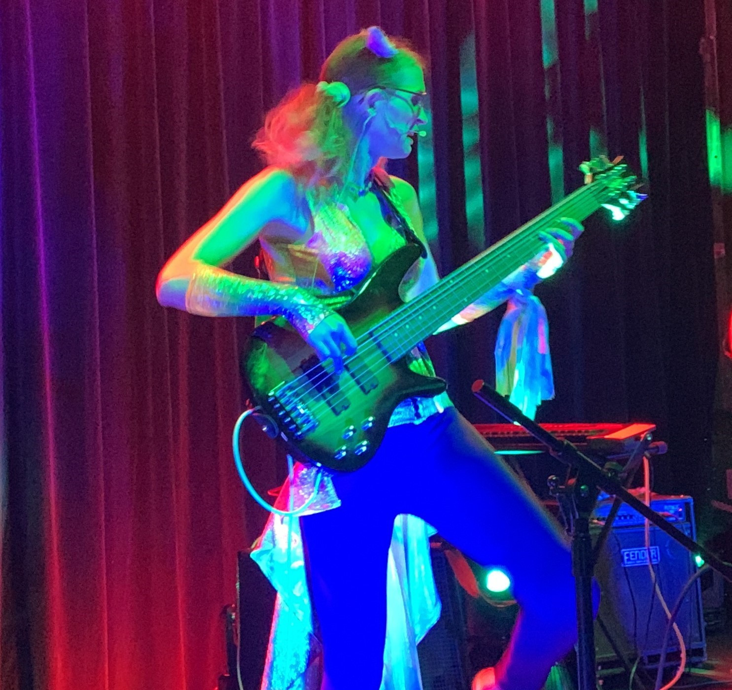 Natalie onstage at Anthrocon during the DreamStates performance, playing her 6-string bass guitar.