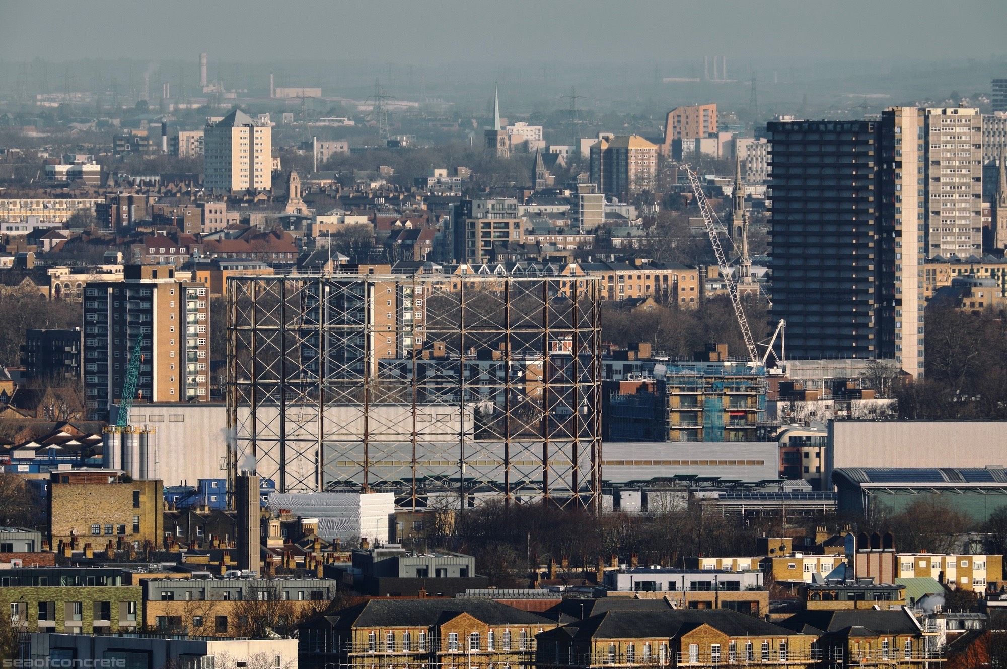 The photo shows the view from Dawson’s Heights estate towards Old Kent Road on a sunny February morning. The gigantic Maydew House tower block and Devon Street gasometer are visible.