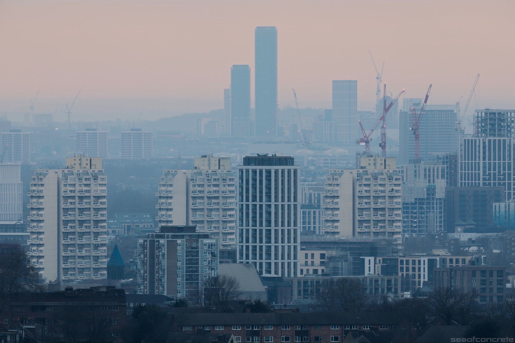 This photo was taken from the Dawson’s Heights Estate on a cold, misty February morning. George Finch’s iconic Grantham Road estate tower blocks are in the foreground and One West Point’s Tower 1, the tallest building in West London, is in the distant background, shrouded in mist.