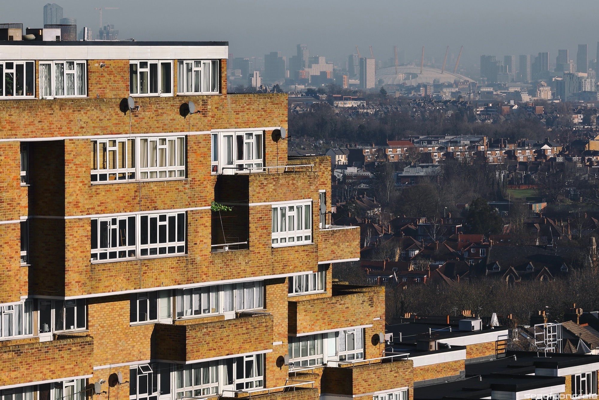 The north block of the Dawson’s Heights estate (called ‘Ladlands’) is illuminated by the early morning sun, with the O2 arena in the distant background.