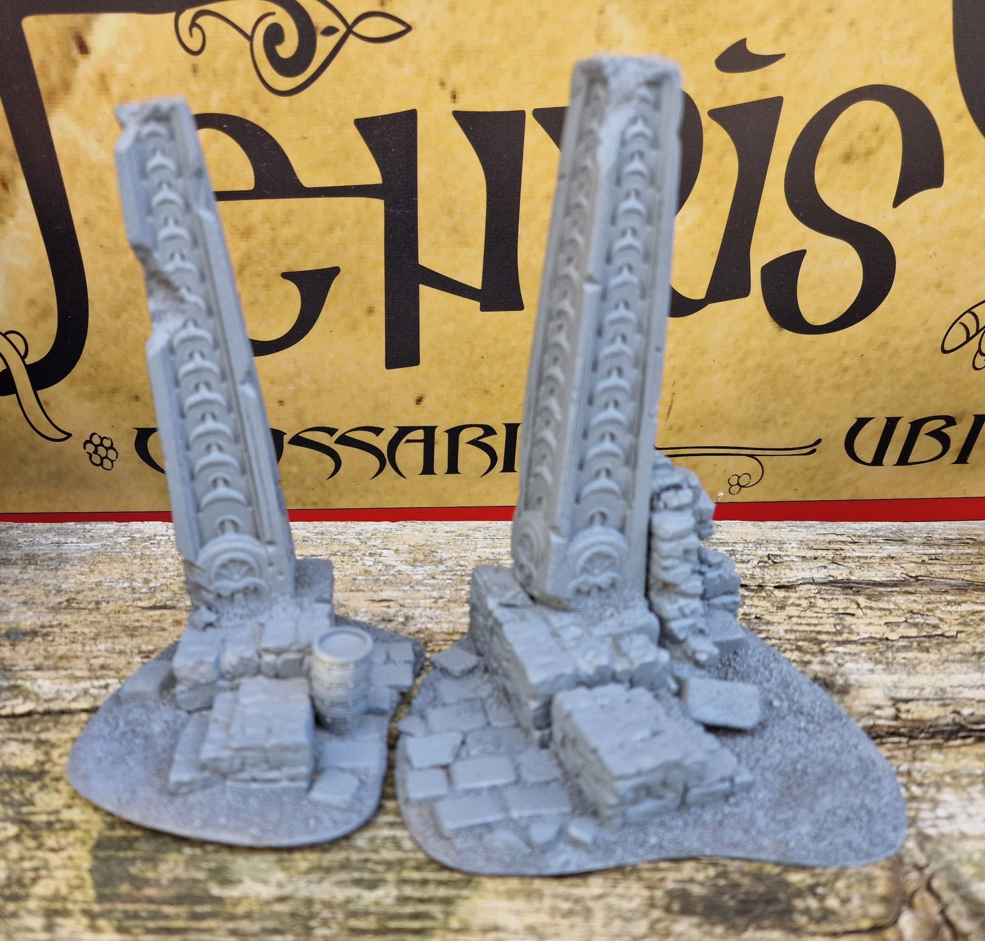 Resin model: two partially ruined obelisks on ancient stone staircases, either side of a flagstone-paved street.