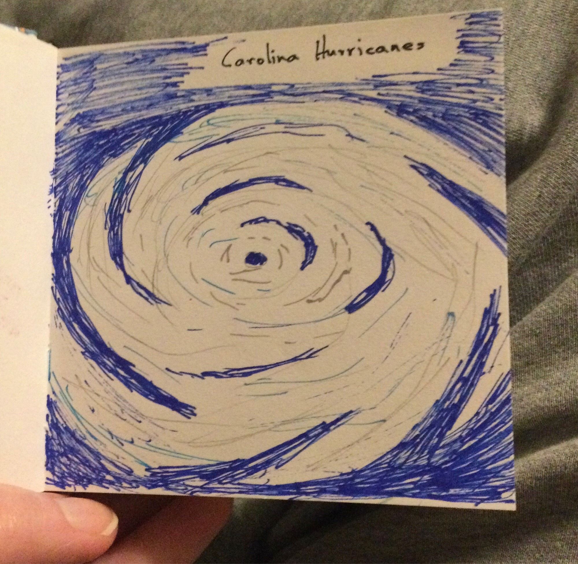 A hurricane sketched in blues and grays on white paper.