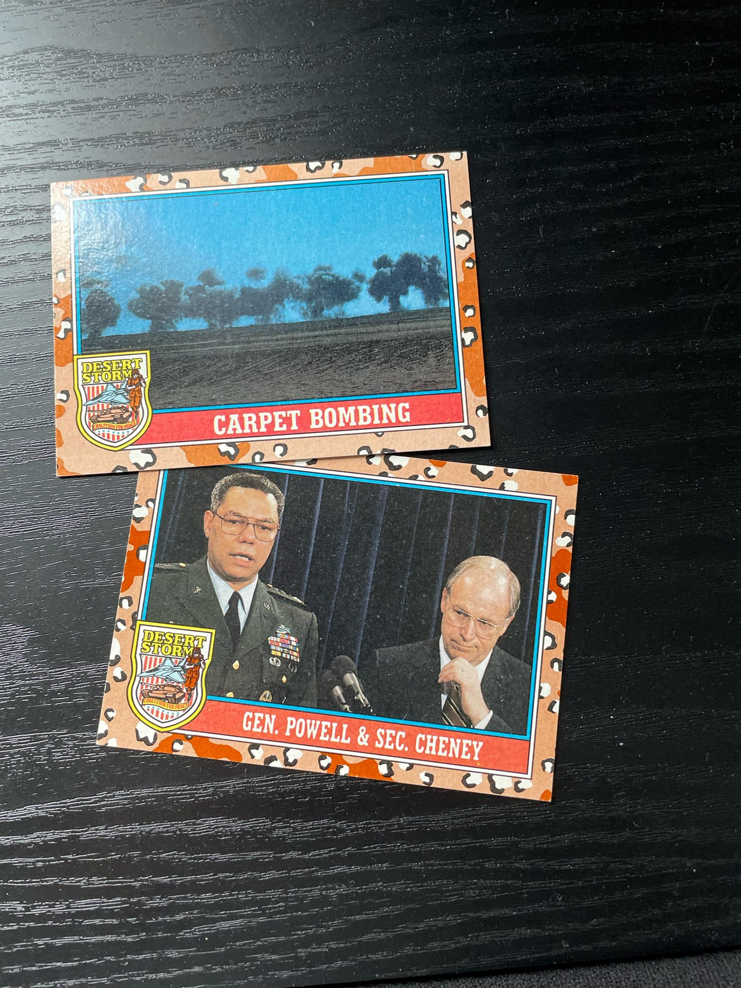 Gulf war trading cards depicting carpet bombing and general powell and secretary cheney.