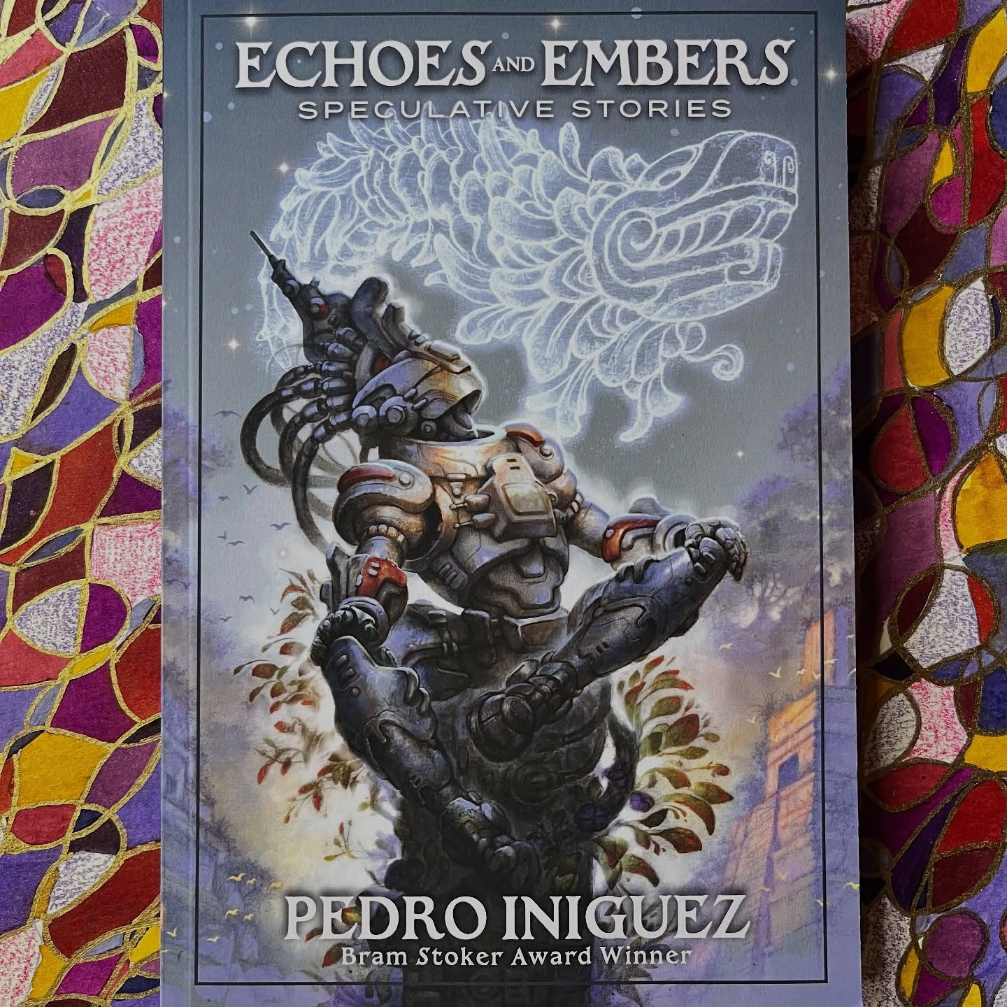 Echoes and Embers: Speculative Stories by Pedro Iniguez, cover art by Raul Cruz (RACRUFI)
Background abstract mixed media art by Jendia Gammon.