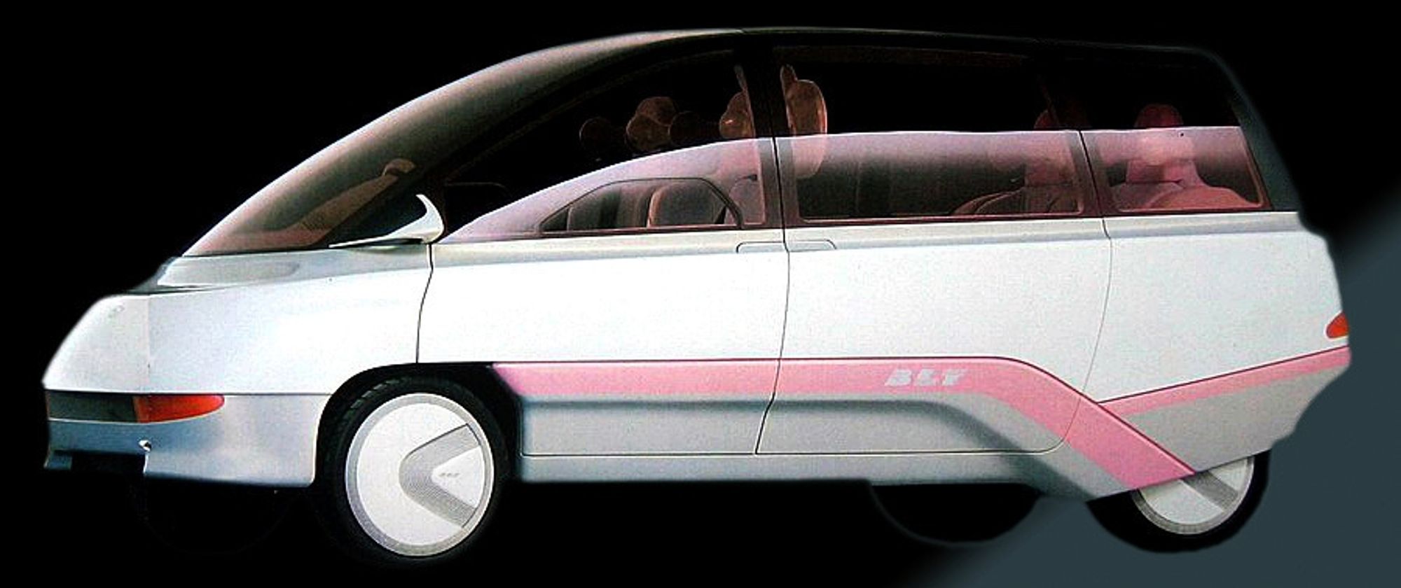 A very 1987 capsule-smooth space aged minivan in white and pink