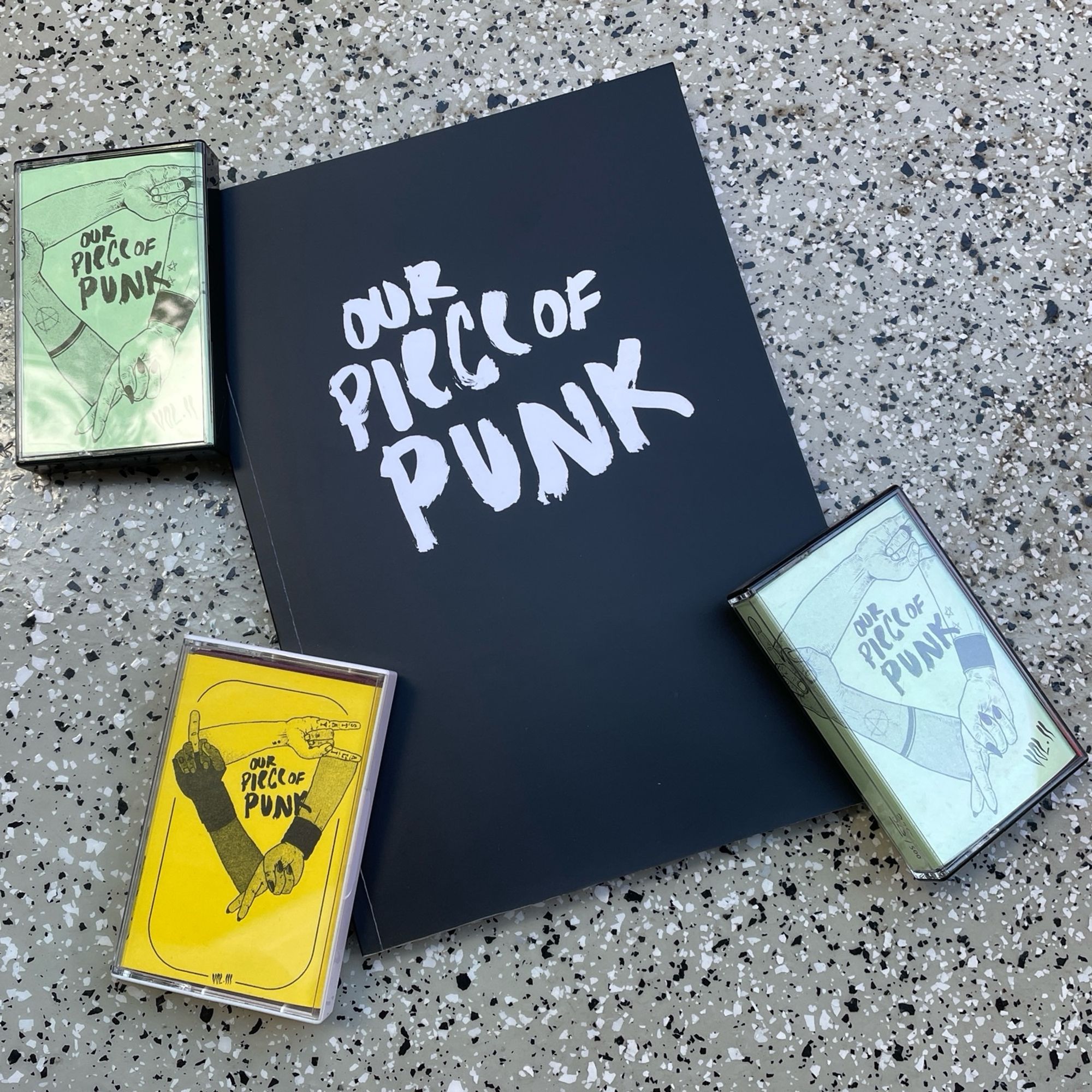 Cover des Buches ‚Our Piece Of Punk. Ein queer_feministischer Blick auf den Kuchen‘ und die Tapesampler II, II und III