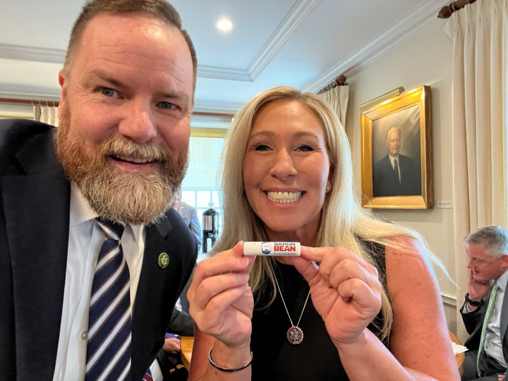 Marjorie Taylor Greene holding the chapstick used by Kevin McCarthy that she won. 