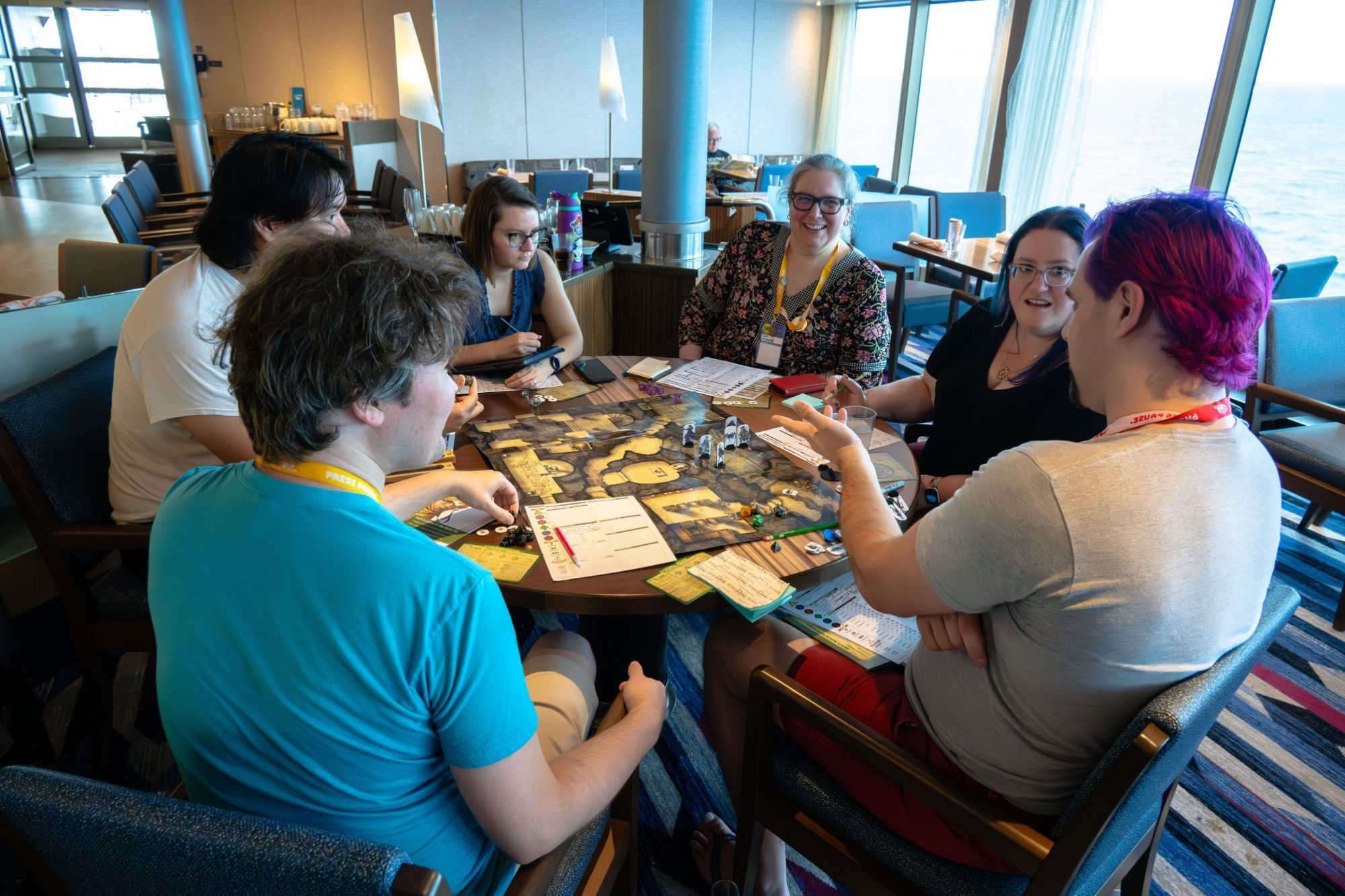 The same group of people playing Pathfinder, but from a different angle.