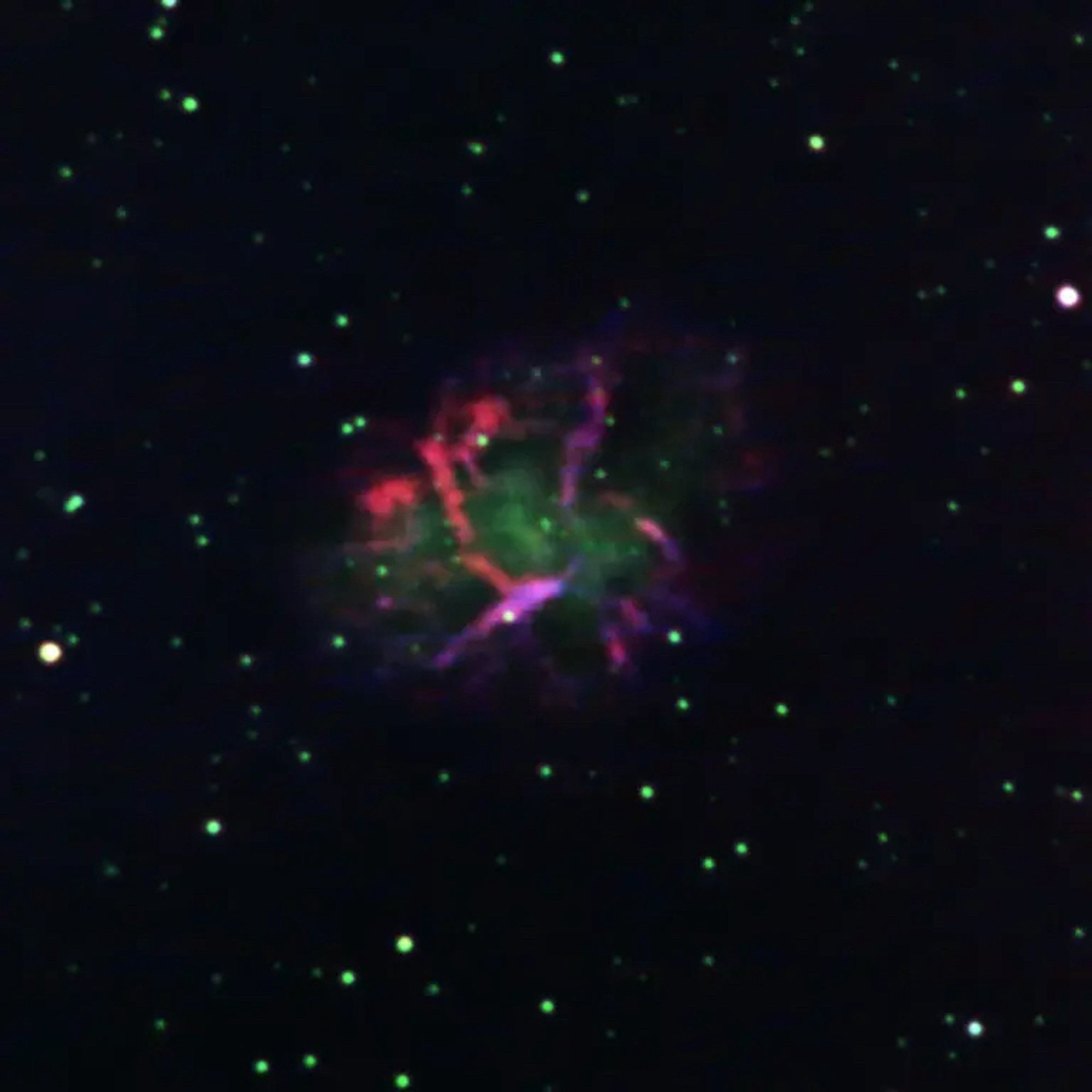 A green red and purple nebula (it’s the Crab Nebula)