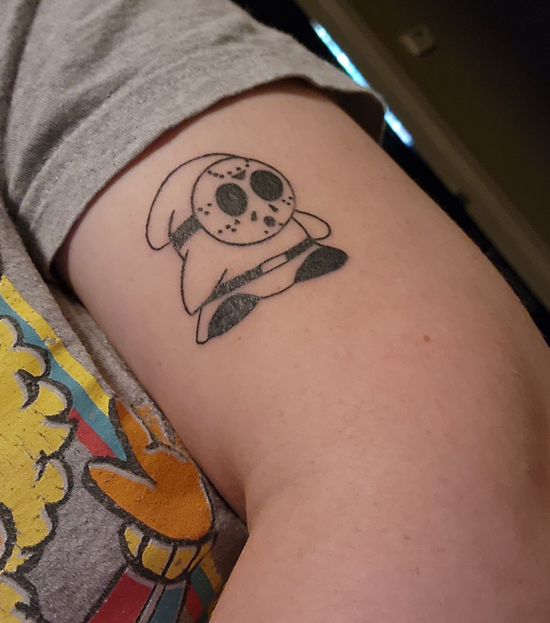 Shy guy tattoo with Jason mask. He is on my upper arm. 