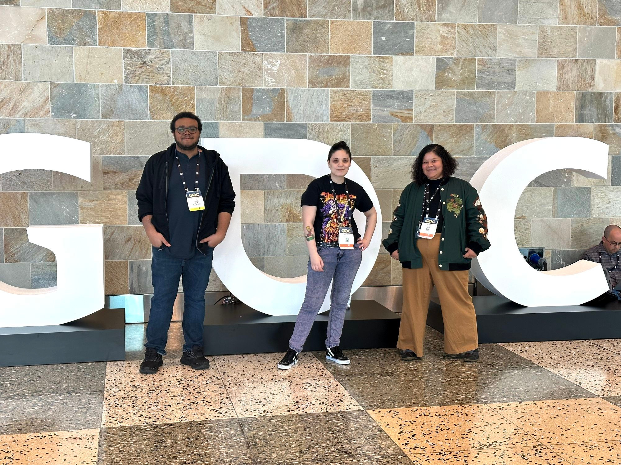 3 of the Hitsuji team standing in front of the GDC sign