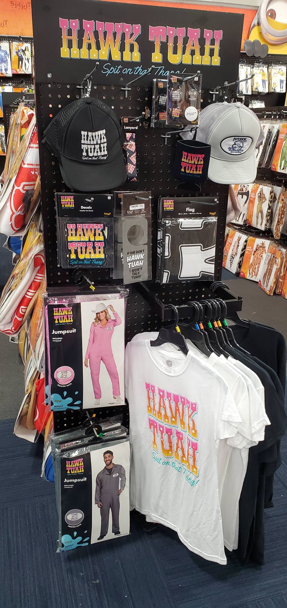 a booth of hawk tuah merch in a spirit halloween store