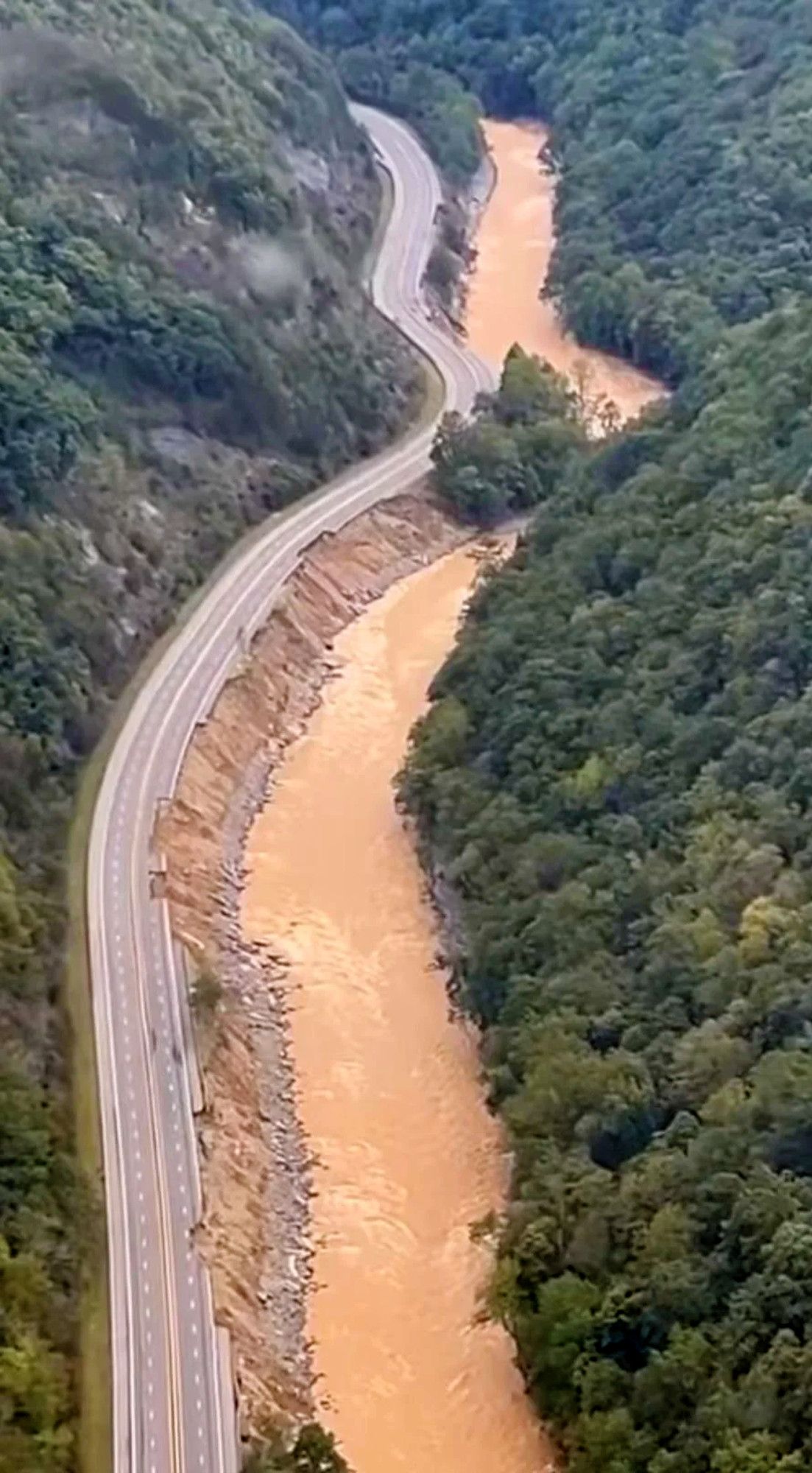 I-40 showing multiple areas of damage along the Pigeon River in NC near what appears to be Mile Marker 2.0