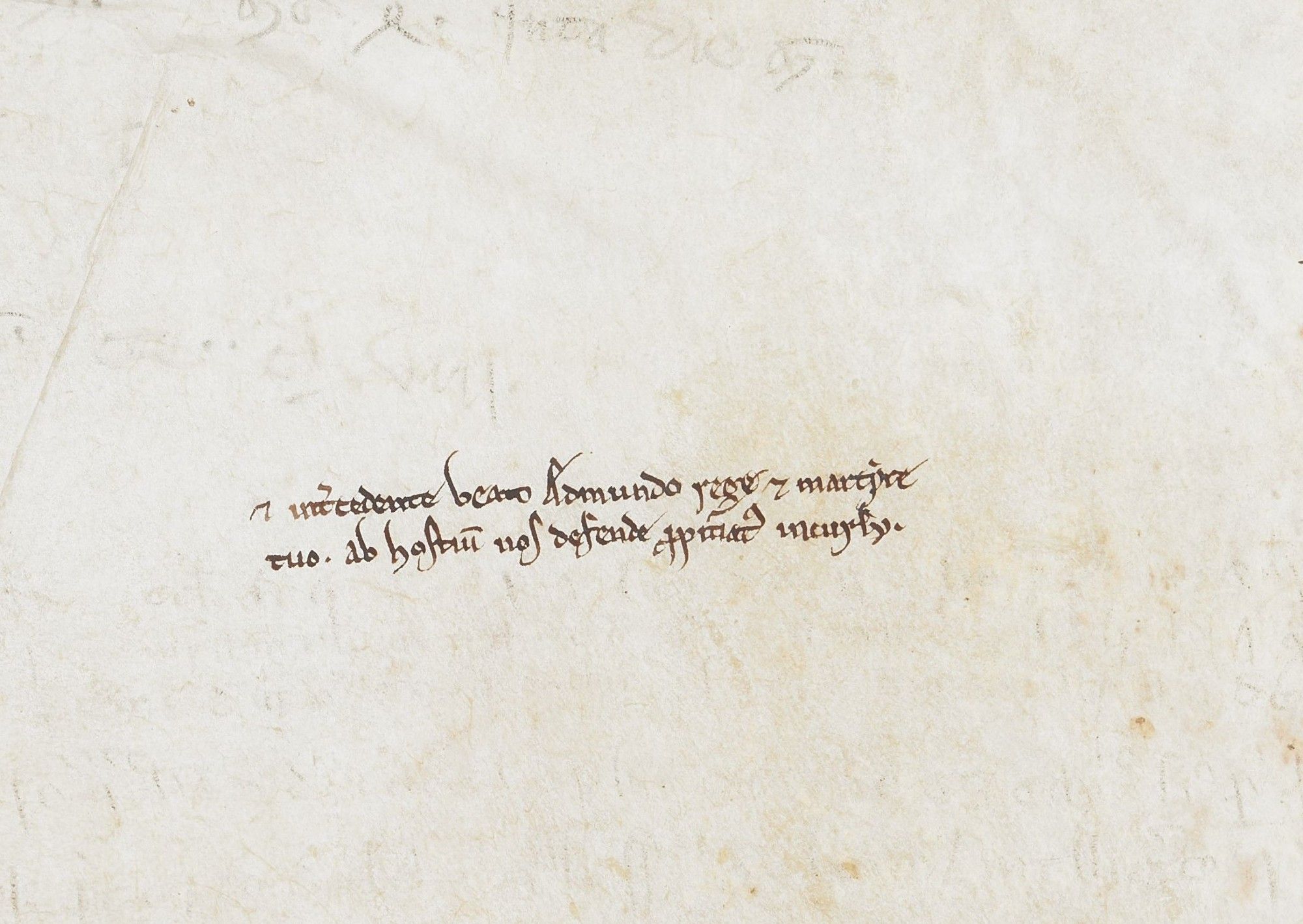 A short prayer for the help of Saint Edmund written on a blank piece of parchment in a thirteenth-century manuscript.