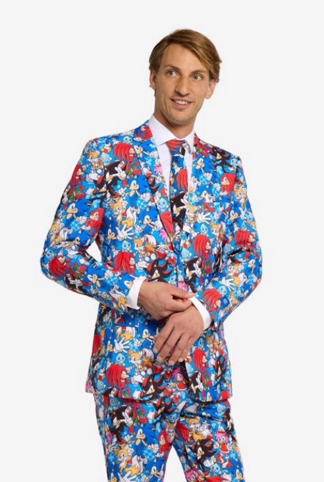 A man in a two piece, sonic the hedgehog themed suit. He is wearing a tie with the same sonic themed pattern.