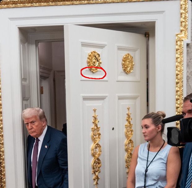 Trump in the oval office with tacky gold painted crap glued on the walls. One particular gold painted whatever-the-fuck it is is glued on a door panel so that overhangs the panel bevel by a good couple inches. Nursery school level craftmanship. 