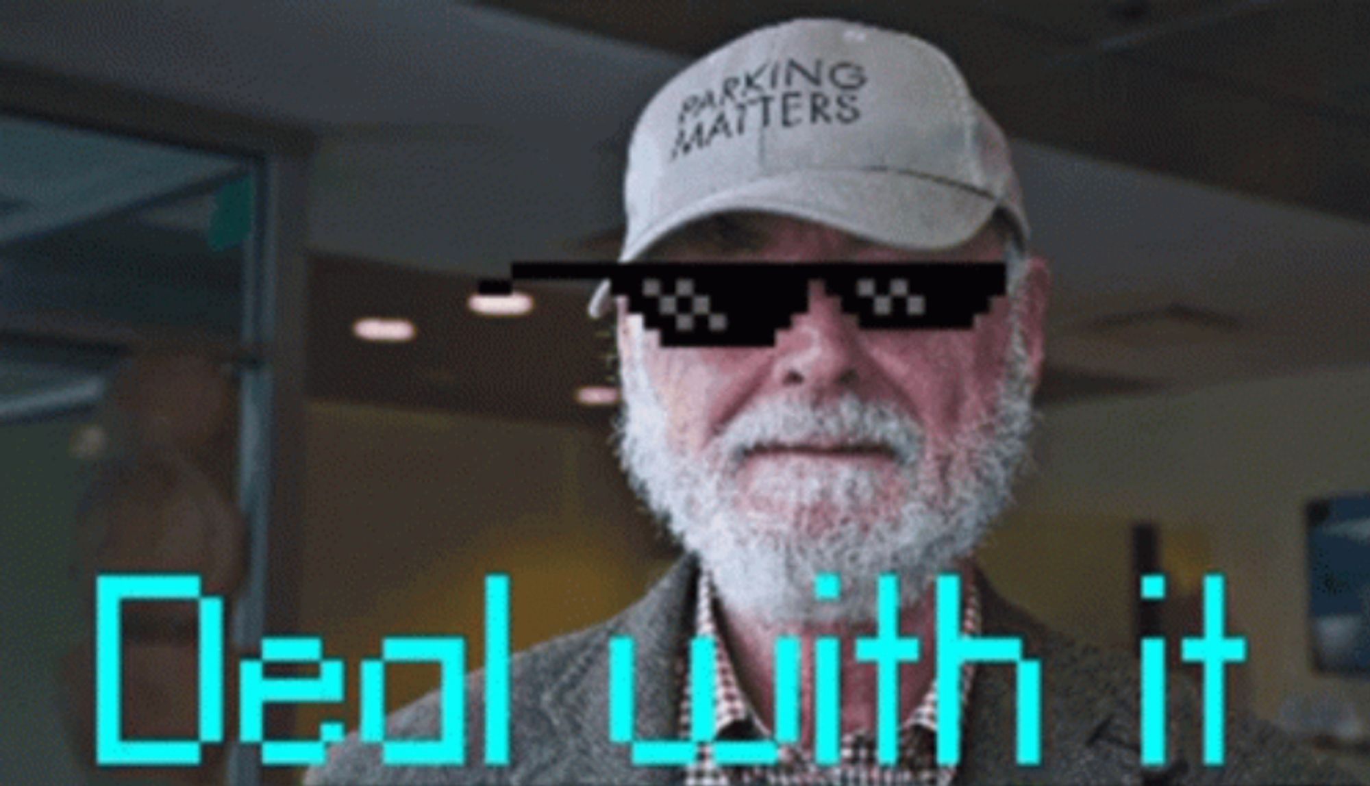 Donald Shoup, parking reform advocate, with sunglasses and text saying "DEAL WITH IT"